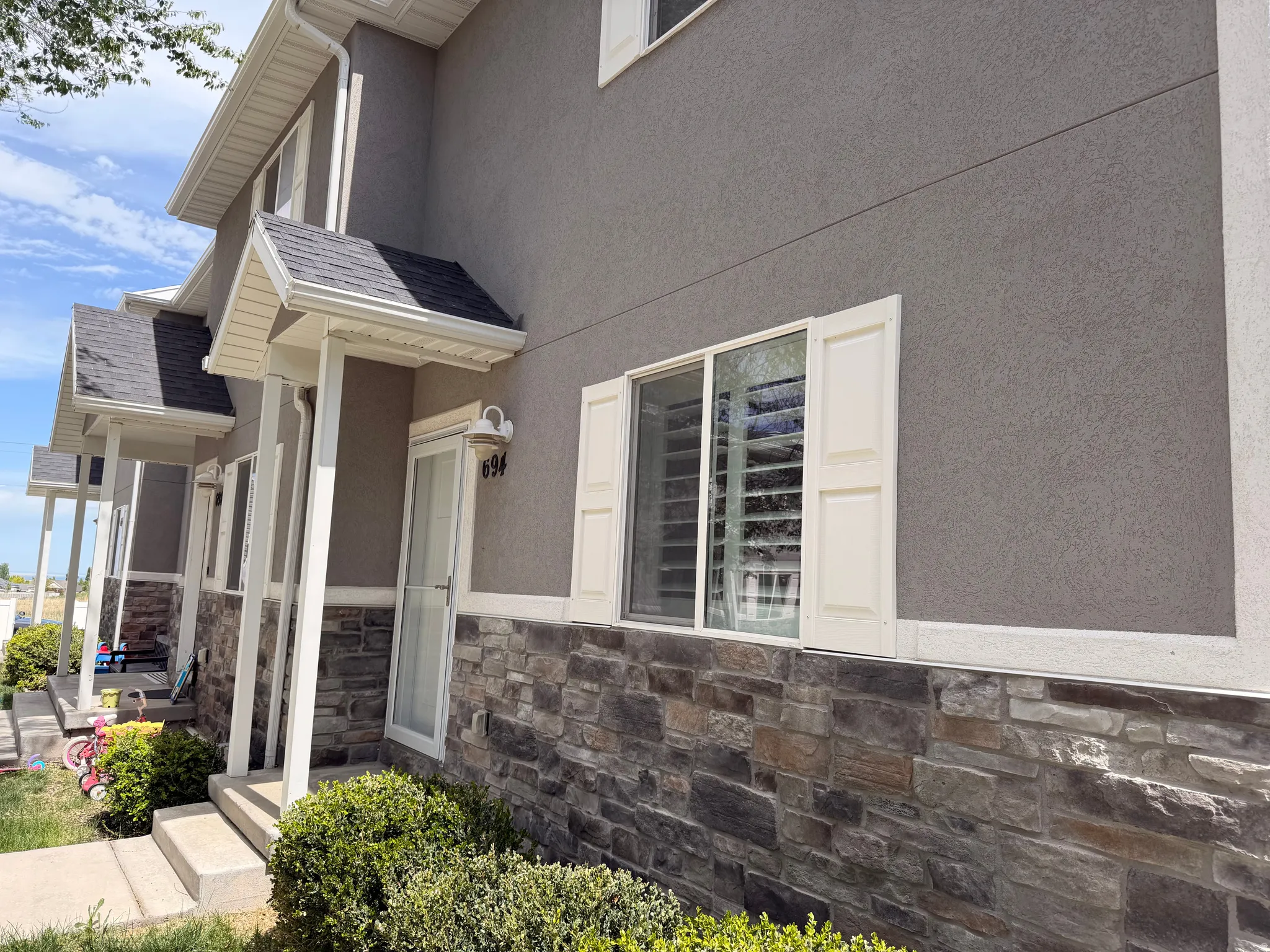 View of home's exterior featuring stone siding and stucco siding