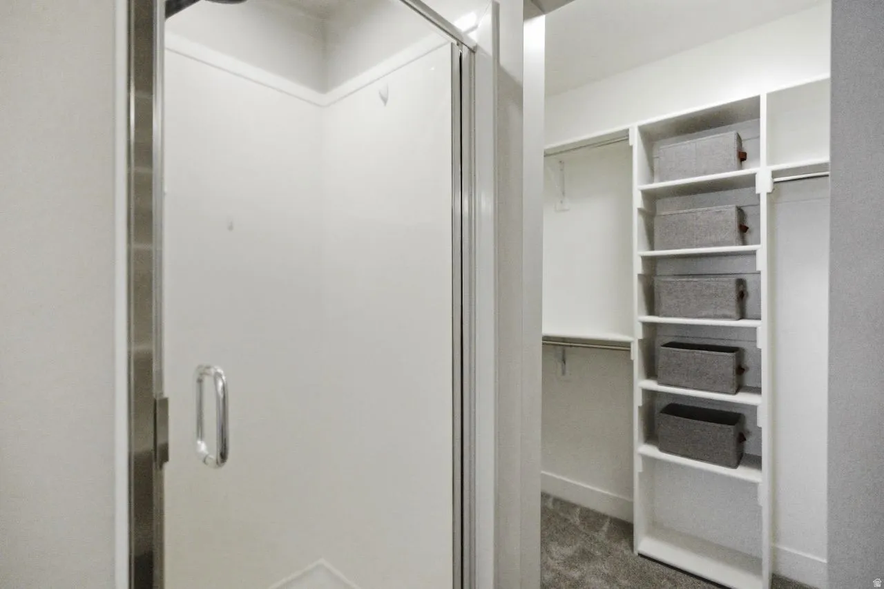 Primary walk in closet and stall shower