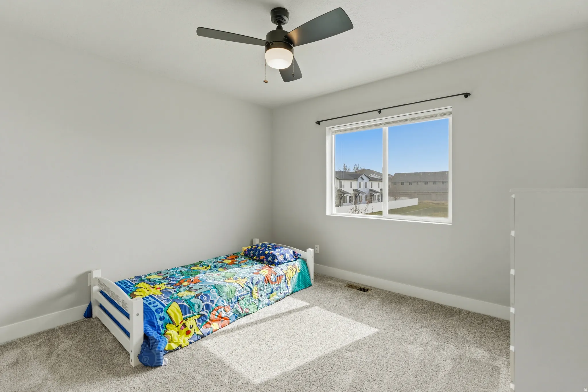 Large bedroom with a ceiling fan