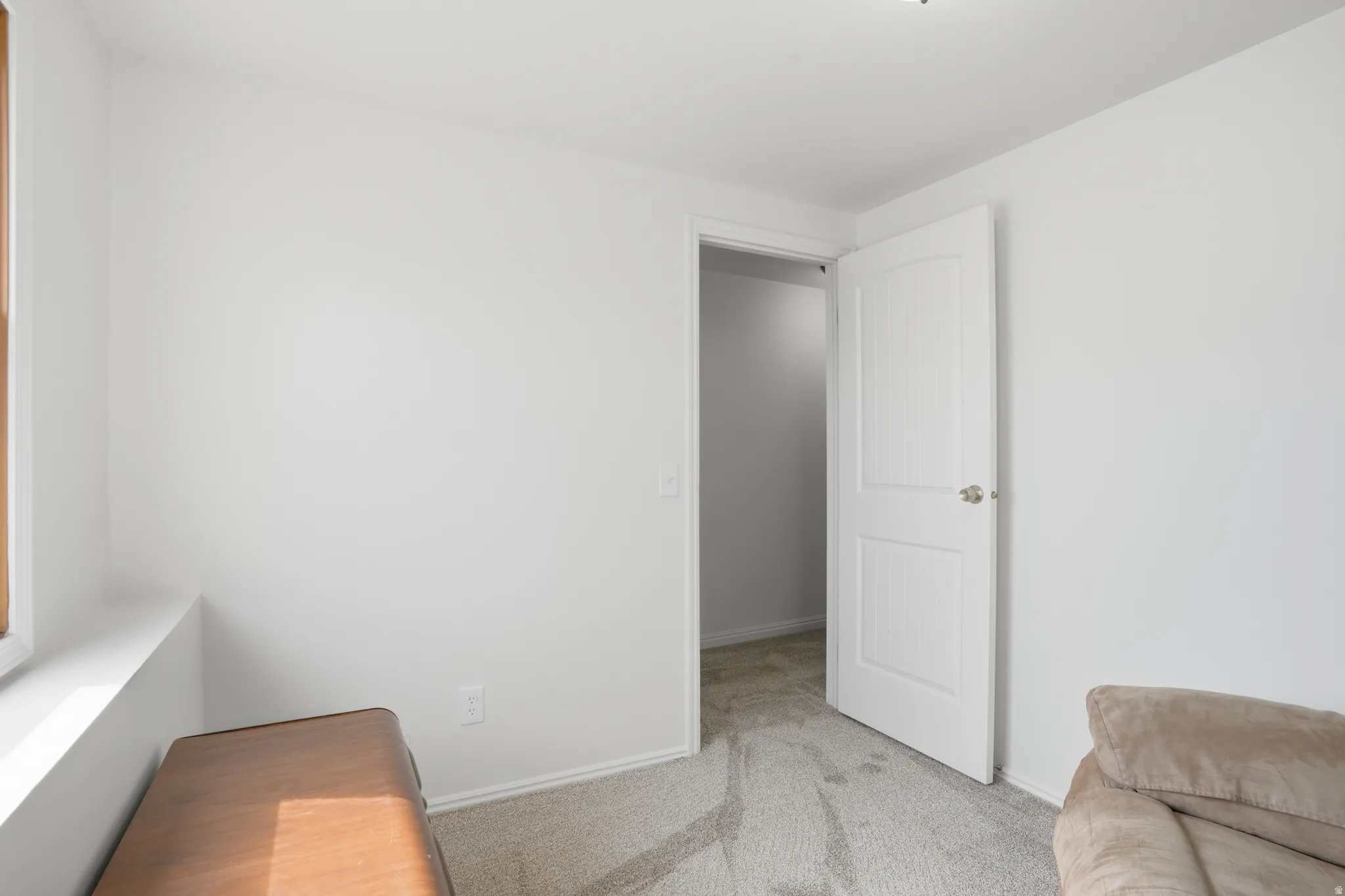 Sitting room featuring light carpet and baseboards