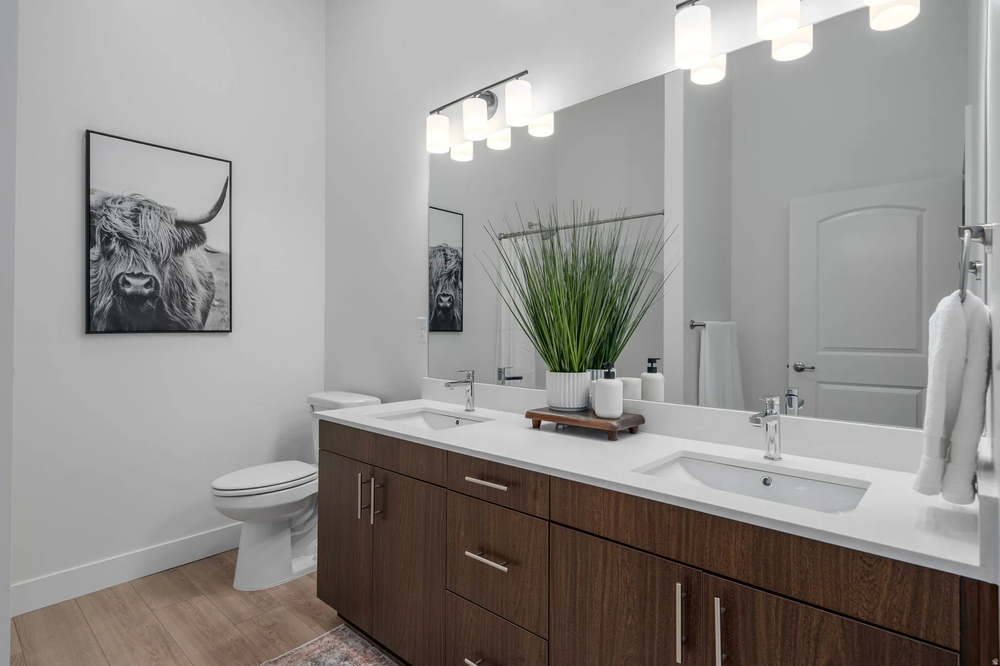 Primary bathroom with double vanity and walk in shower.