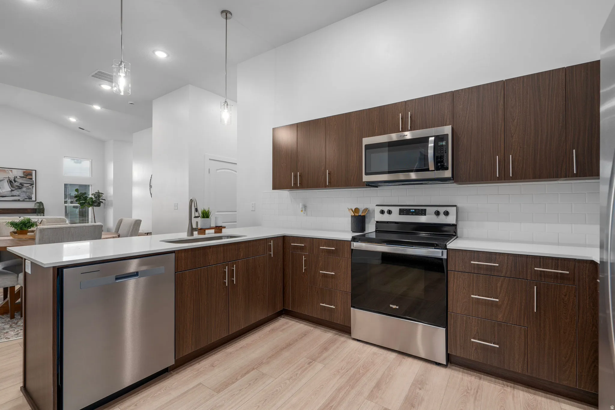 Modern kitchen with dark wood tone cabinets and elevated finishes. *Fridge not included.