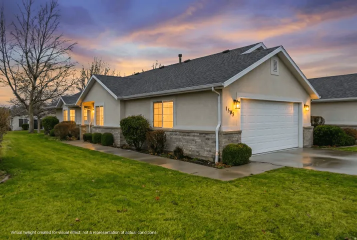 Ranch-style home featuring stucco siding, concrete driveway, stone siding, and a front yard