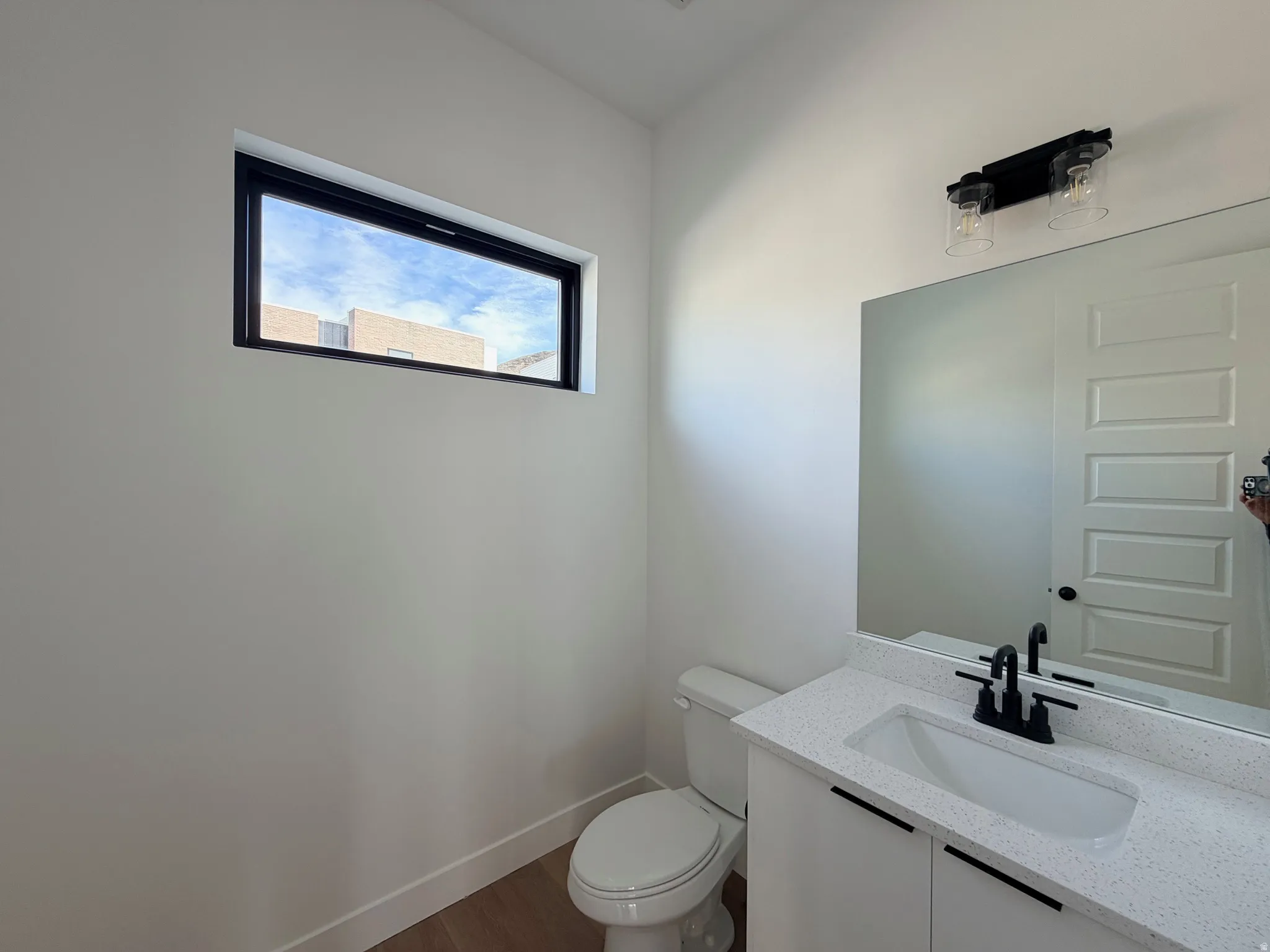Bathroom with vanity and dark wood finished floors