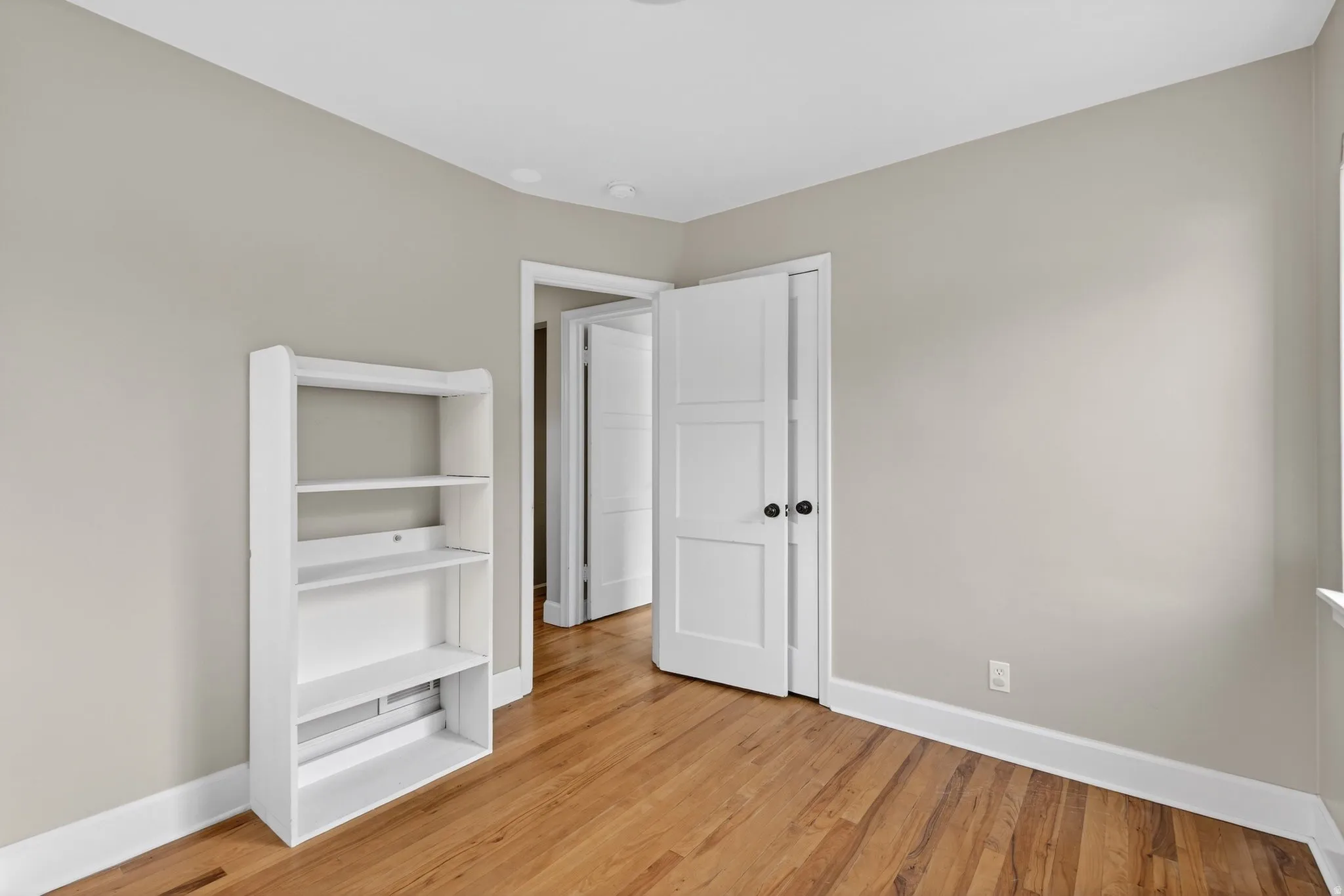 Unfurnished bedroom featuring baseboards and light wood finished floors