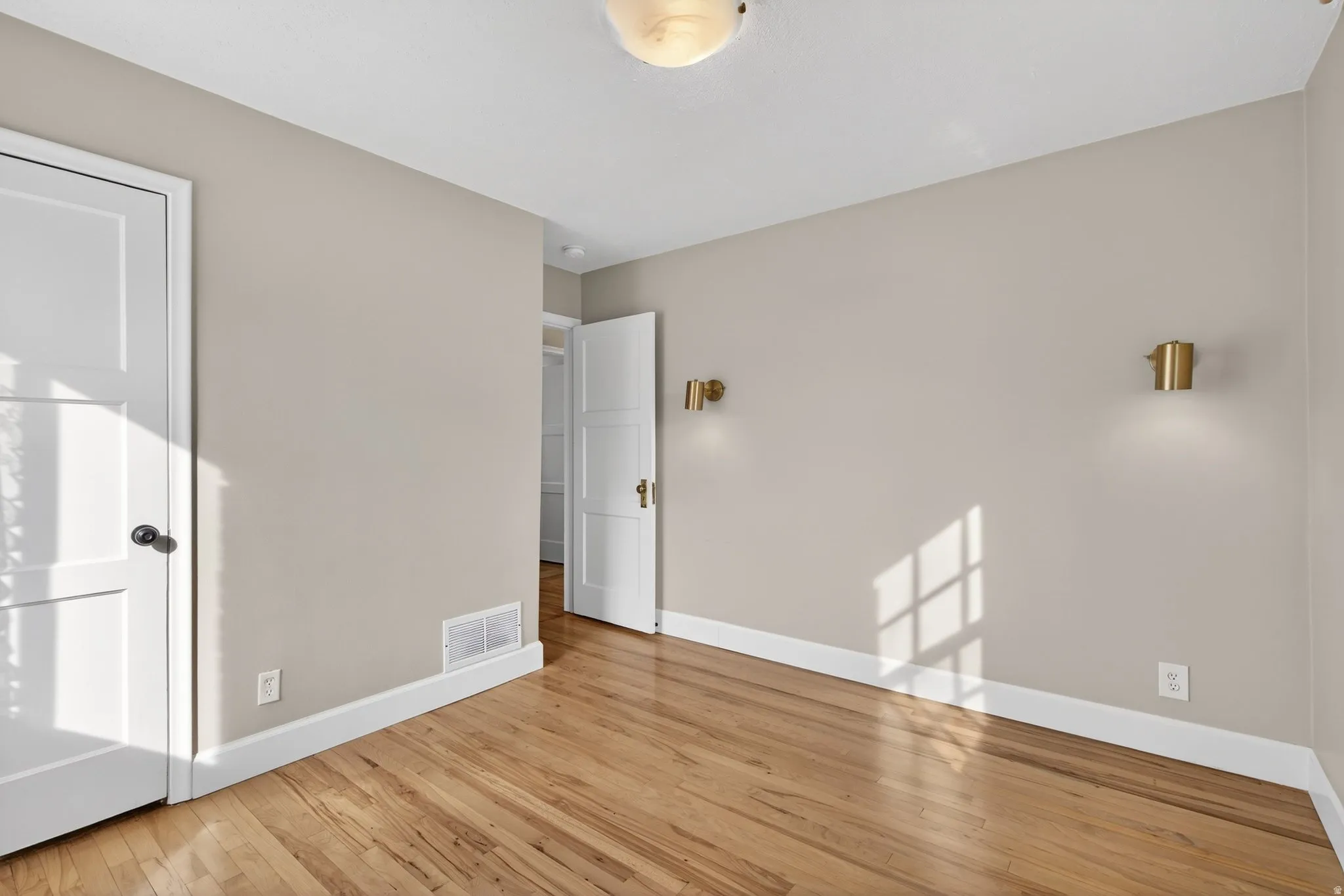 Empty room featuring light wood-type flooring