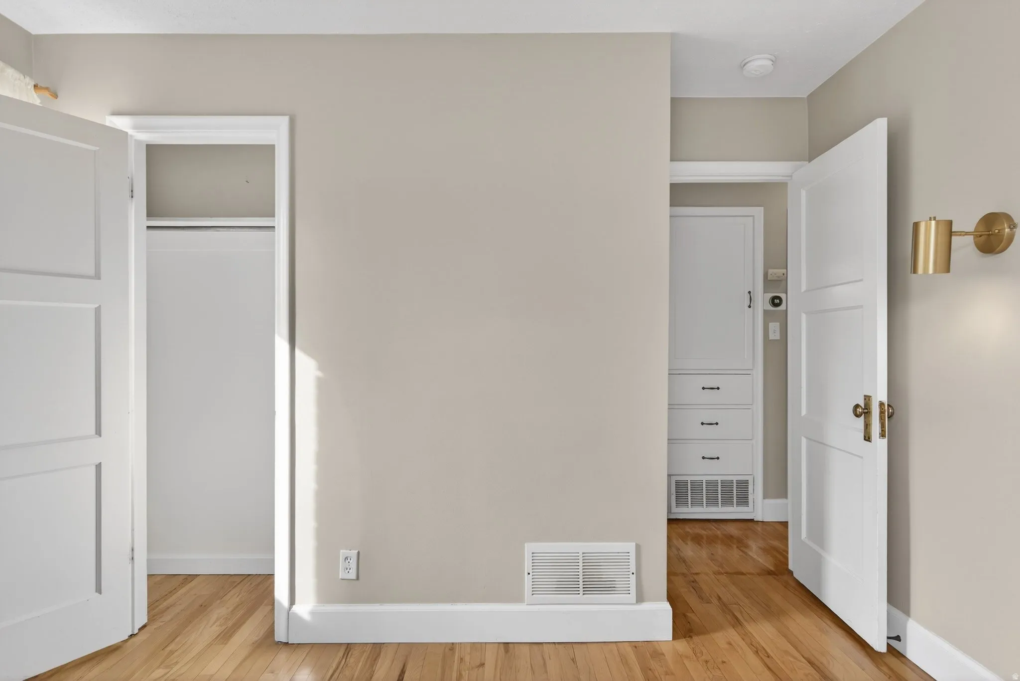 Unfurnished bedroom with baseboards and light wood-type flooring