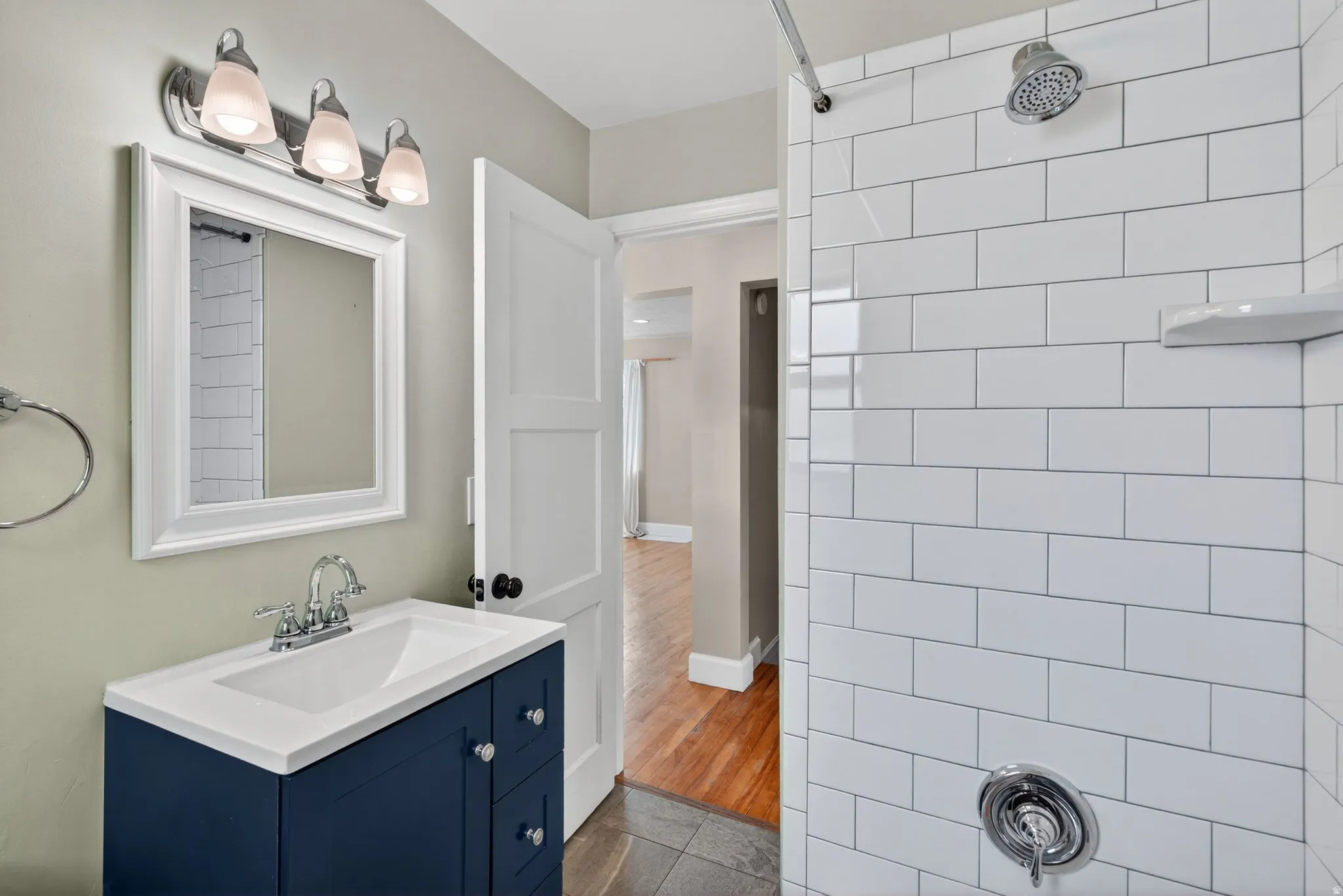 Bathroom featuring vanity, a shower, and tile patterned floors