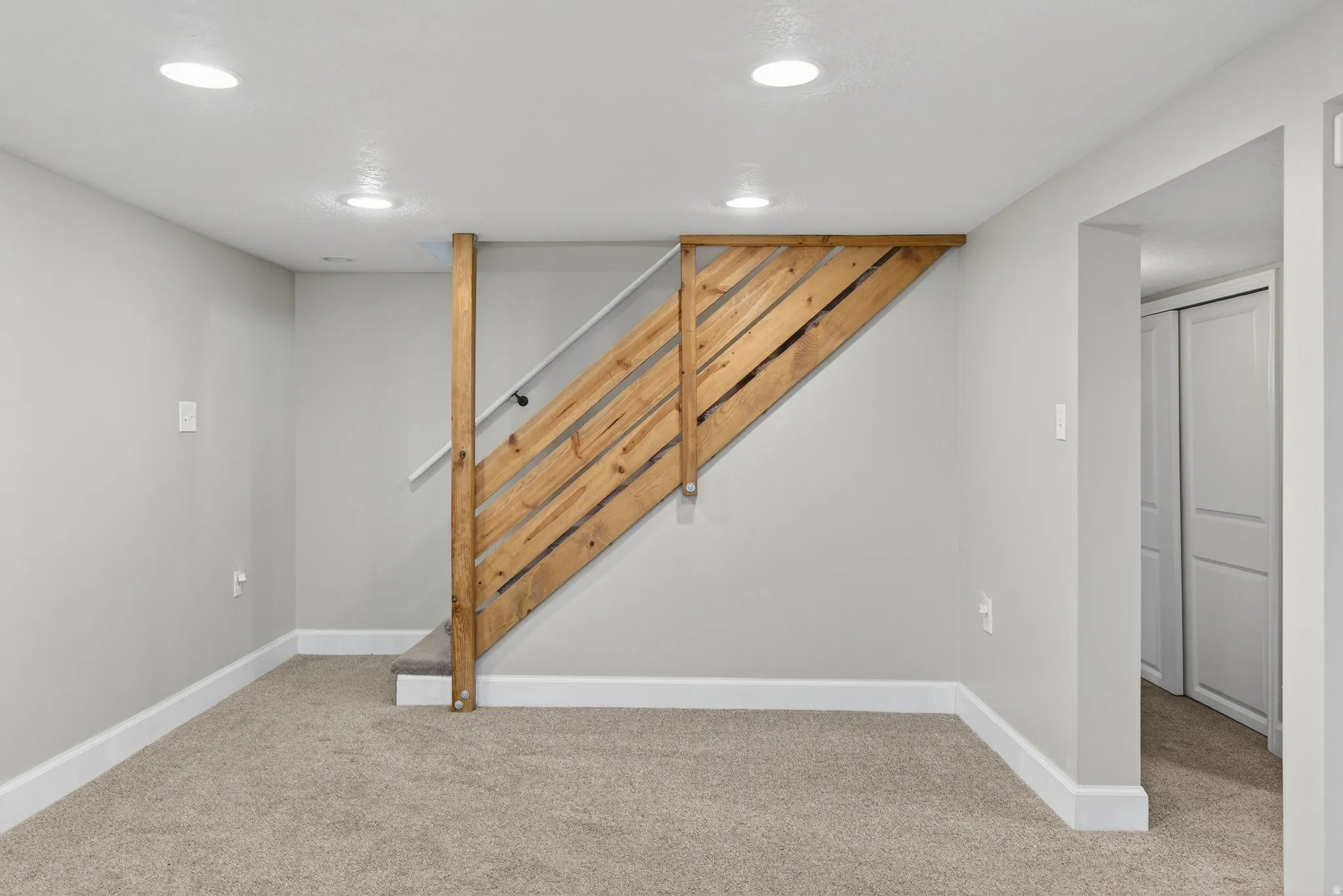 Finished basement featuring light carpet and recessed lighting