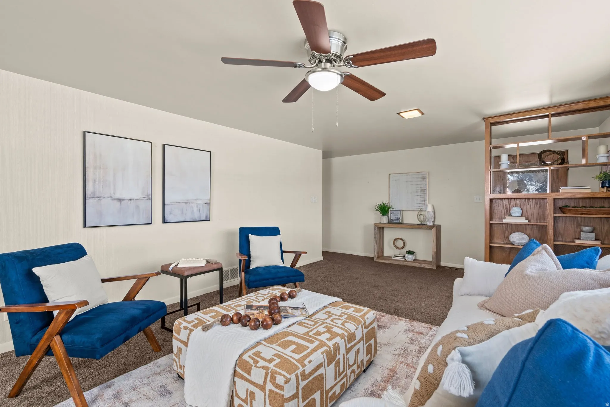 Living area featuring carpet and ceiling fan