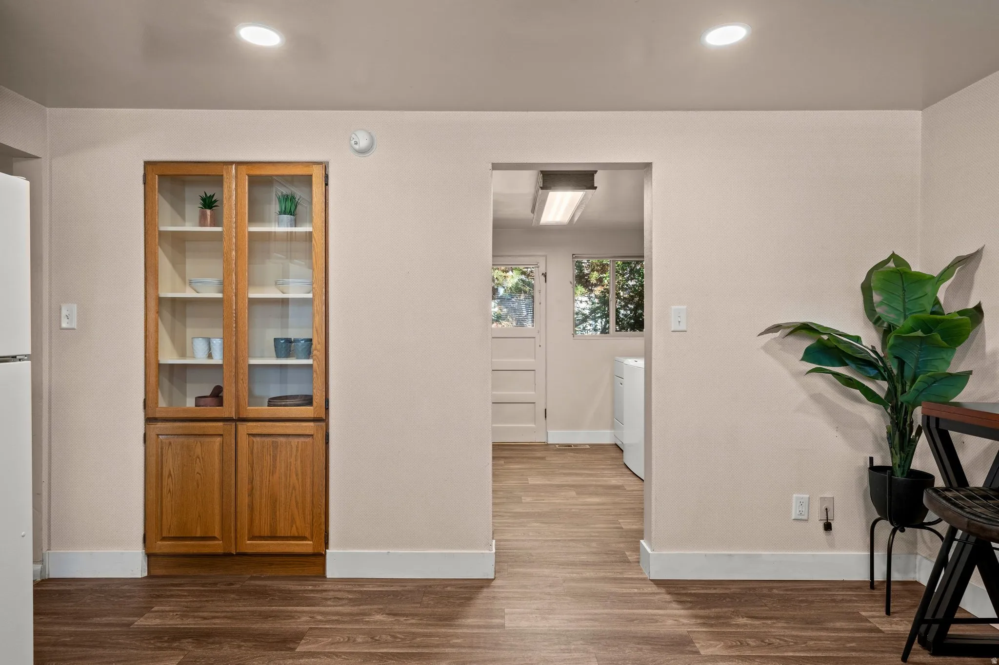 Hall with dark wood-style flooring and recessed lighting
