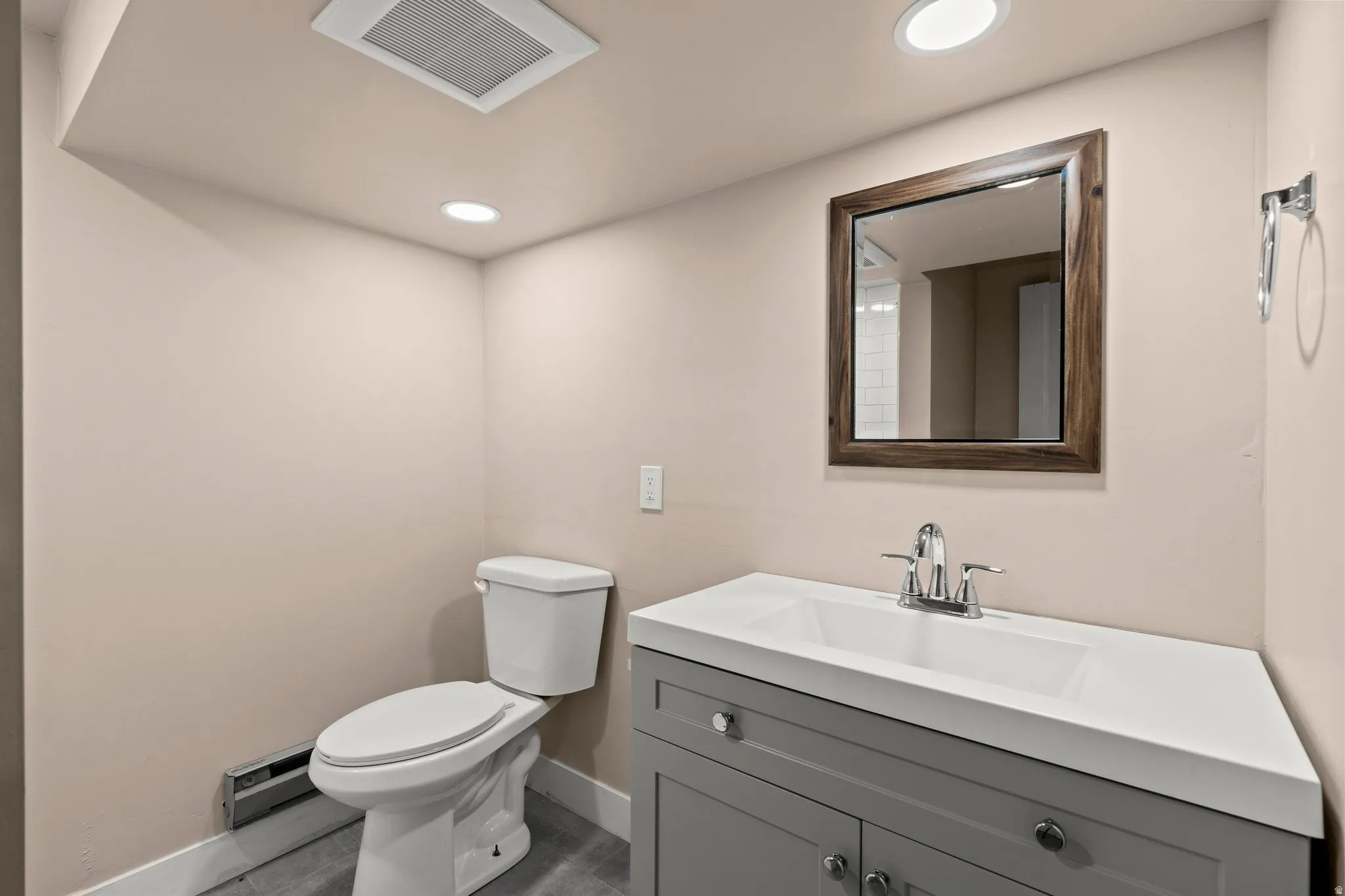 Bathroom featuring vanity, recessed lighting, and a baseboard radiator
