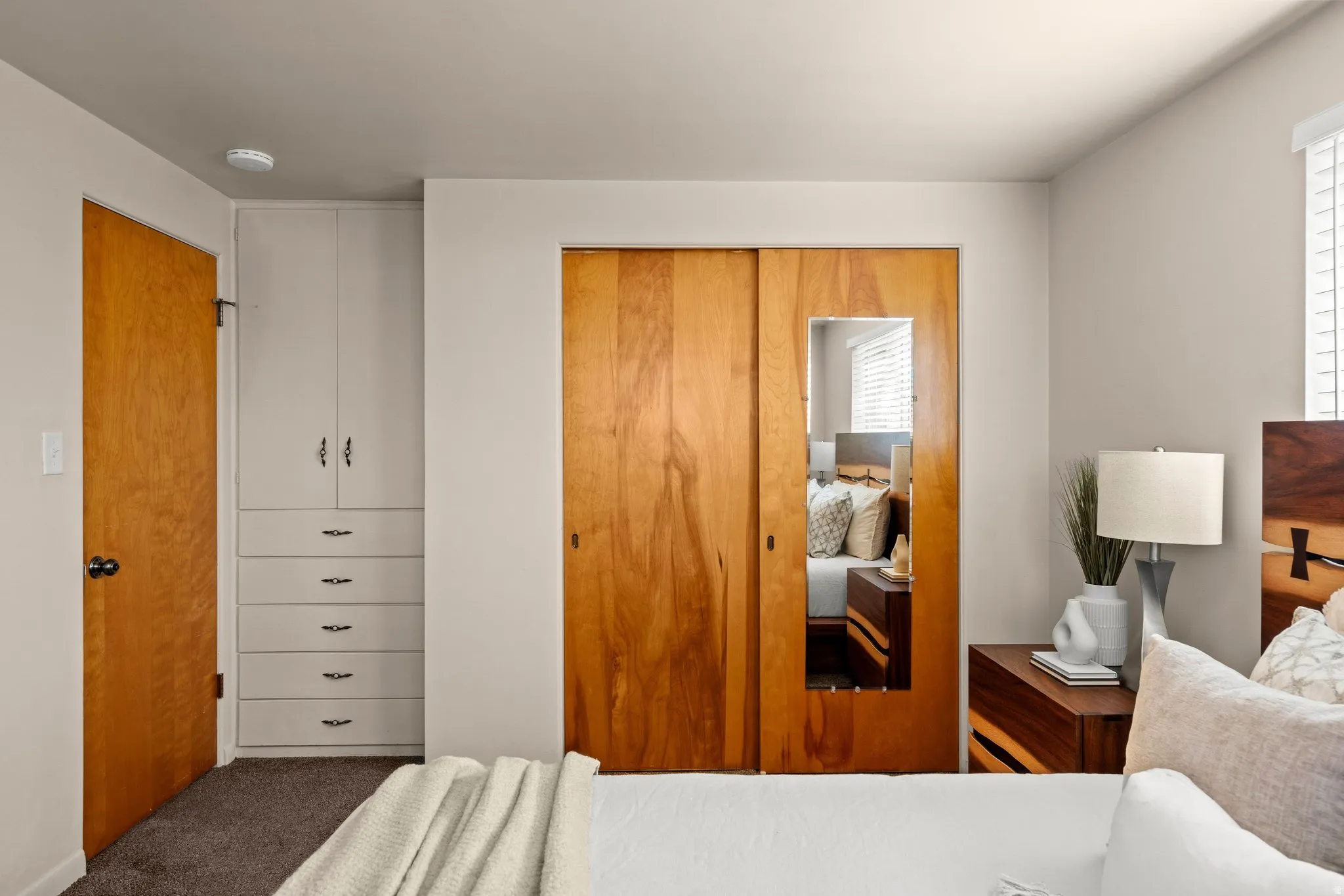 Carpeted bedroom featuring a closet