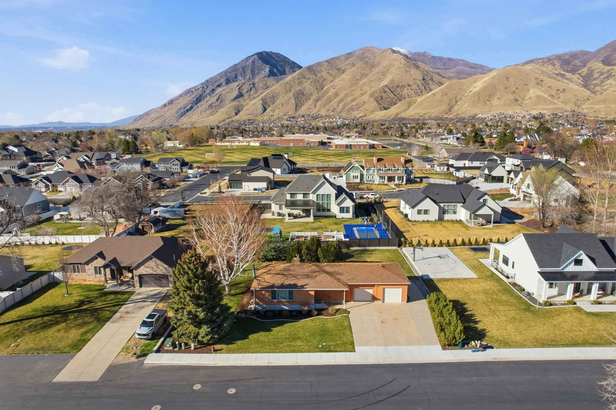 Aerial view of residential area featuring a mountainous background