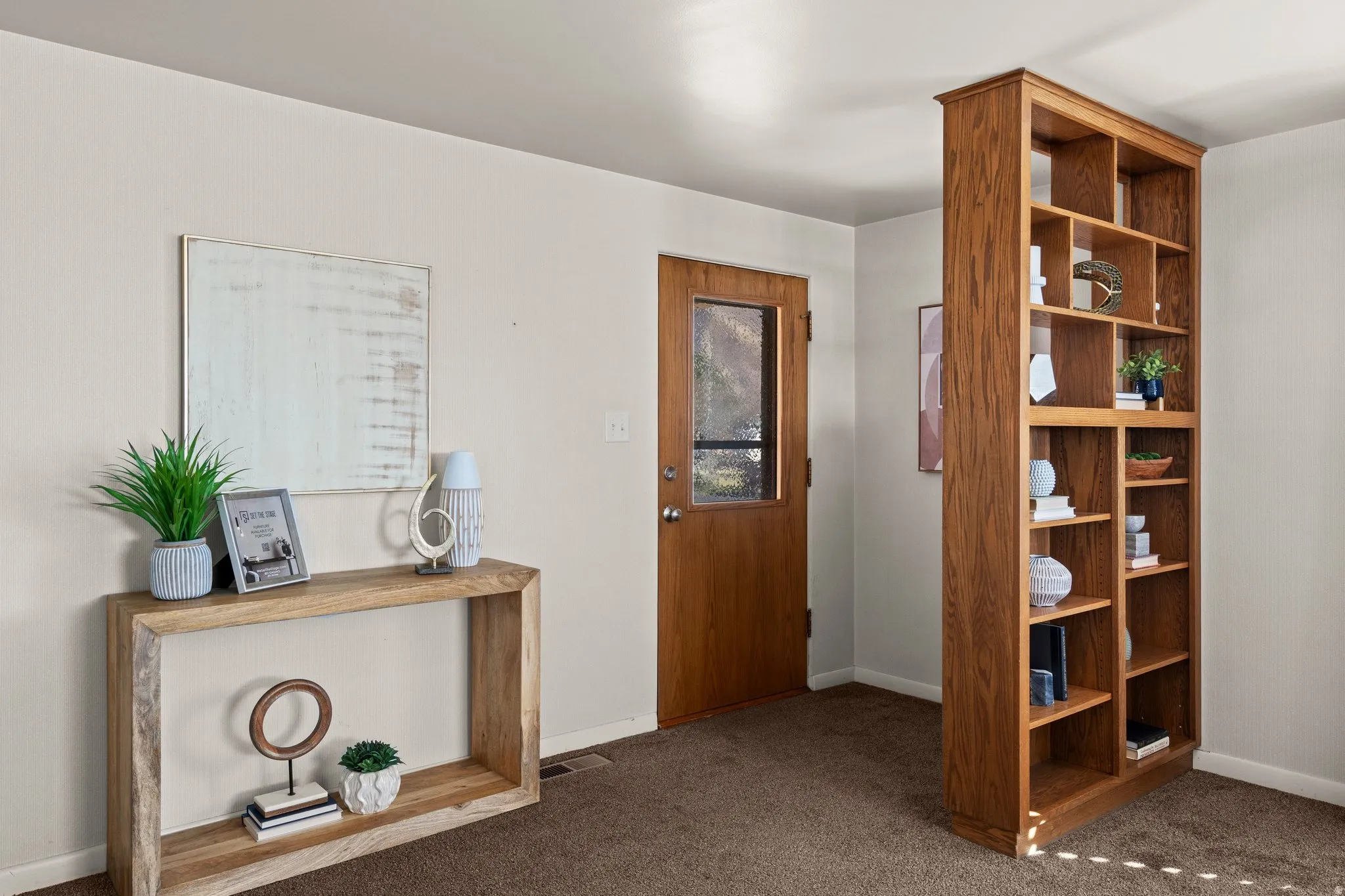 Entrance foyer with dark carpet and baseboards