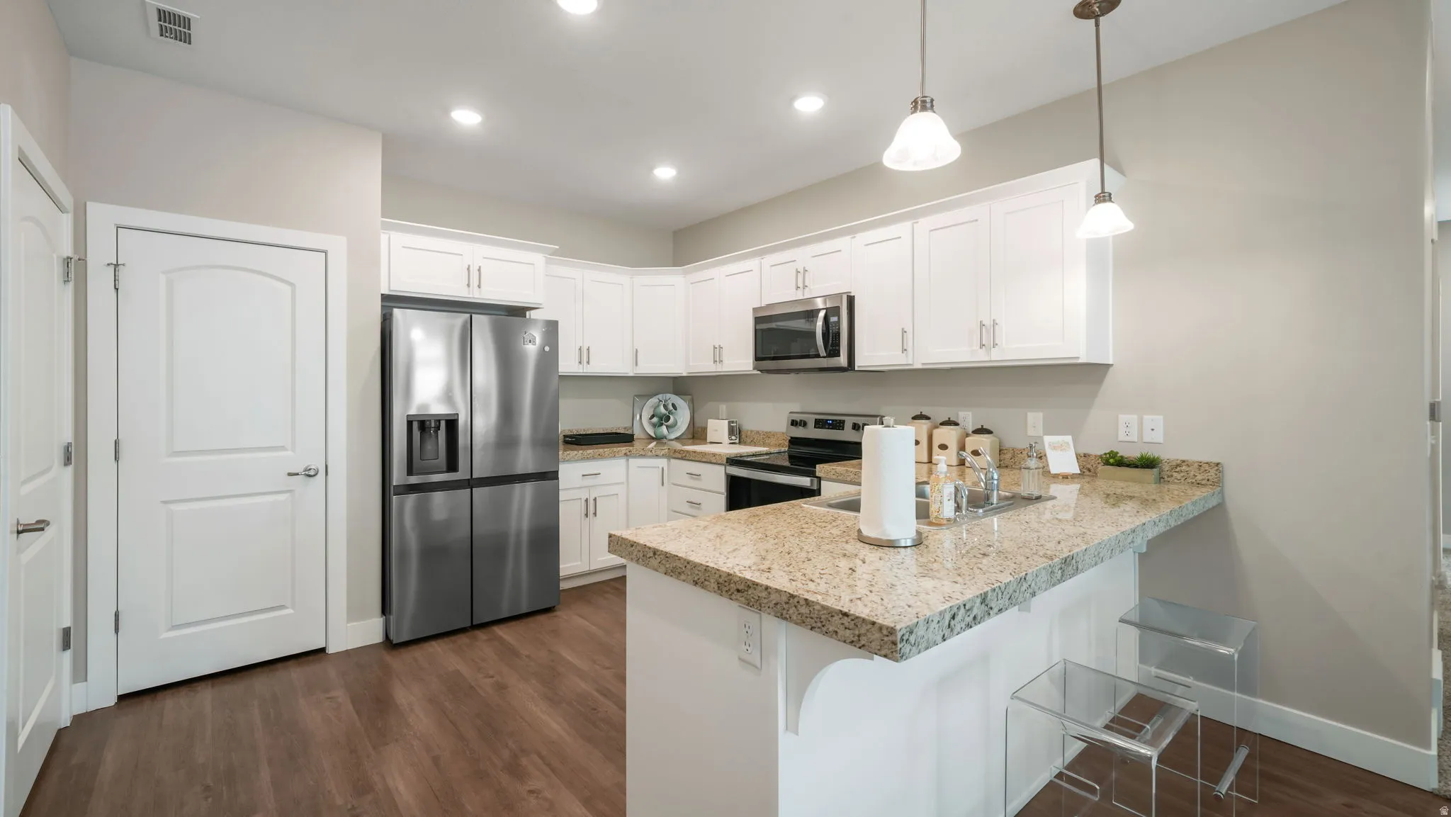 Kitchen featuring white cabinetry