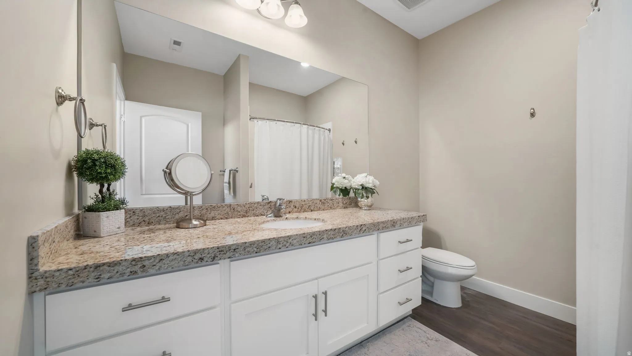 Full bath featuring one sink vanity, roll in shower