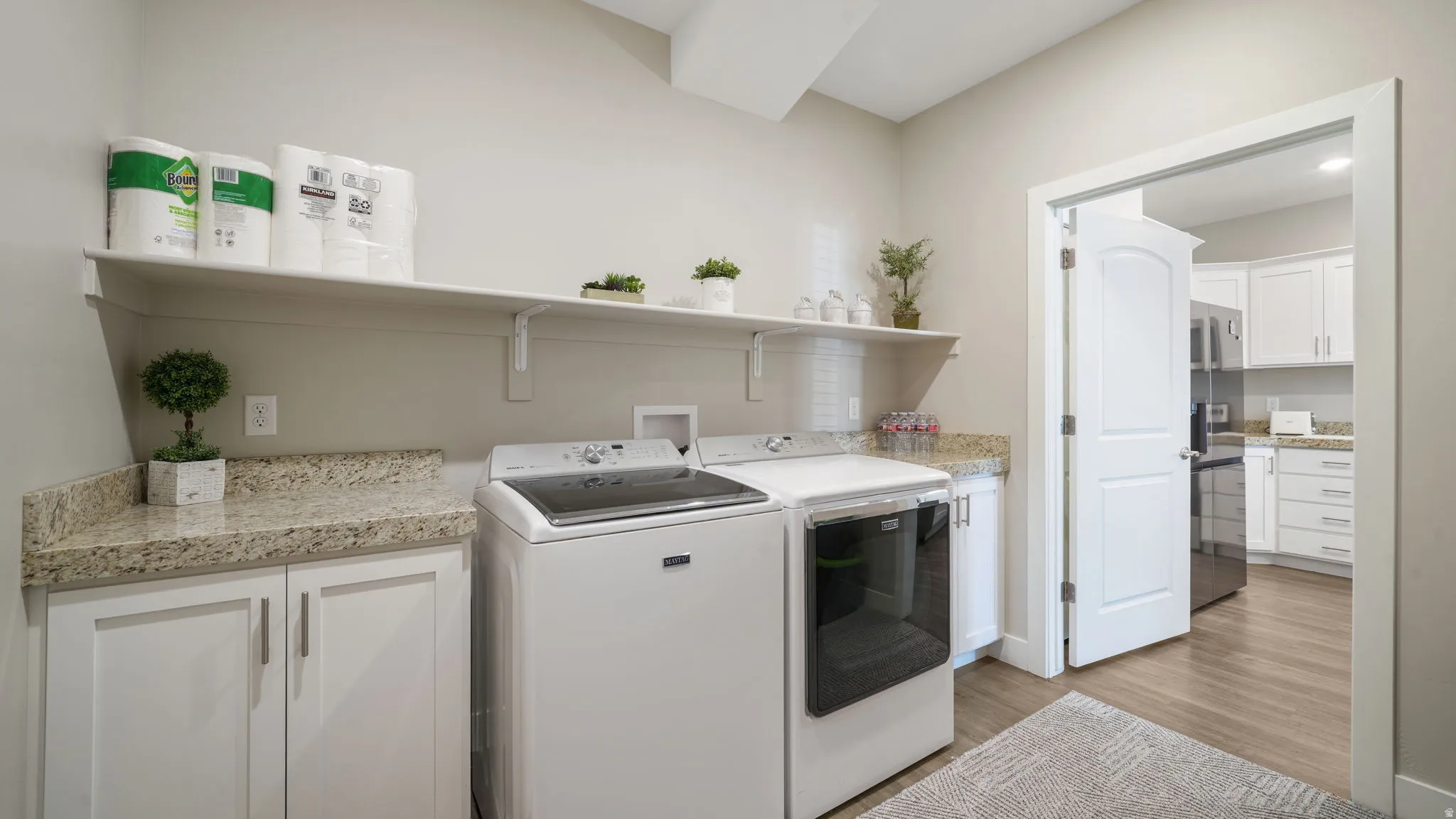 Laundry area with storage closet, garage & service corridor access