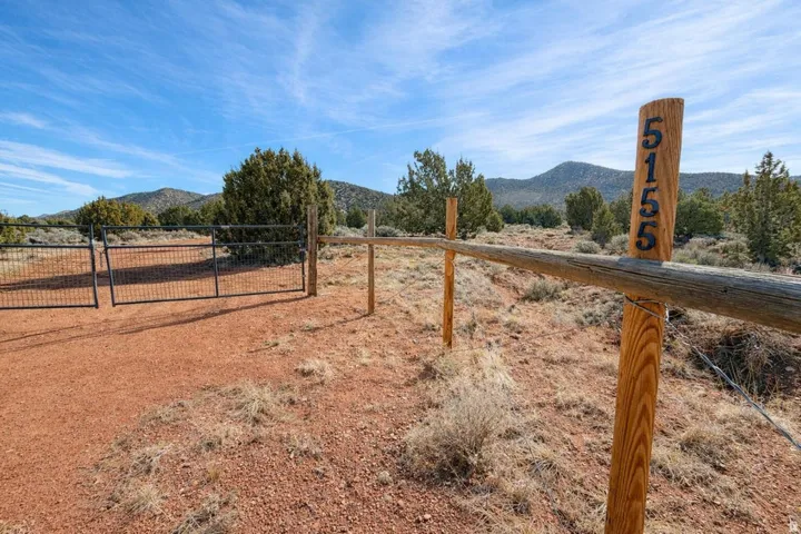 View of yard with a gate and a mountain view