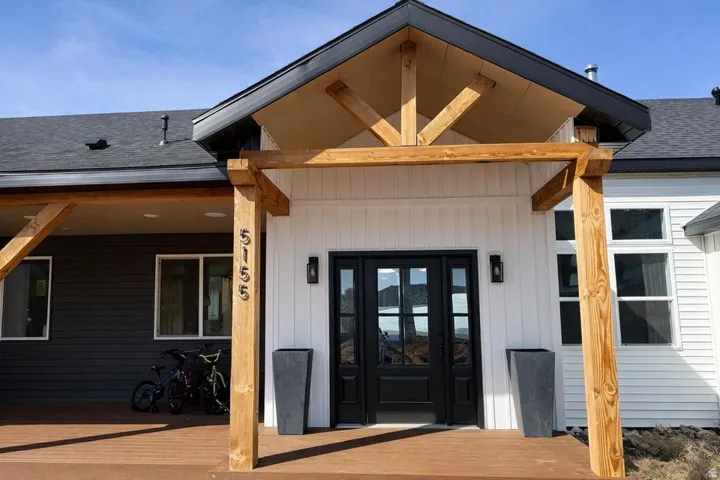 Doorway to property with roof with shingles and french doors