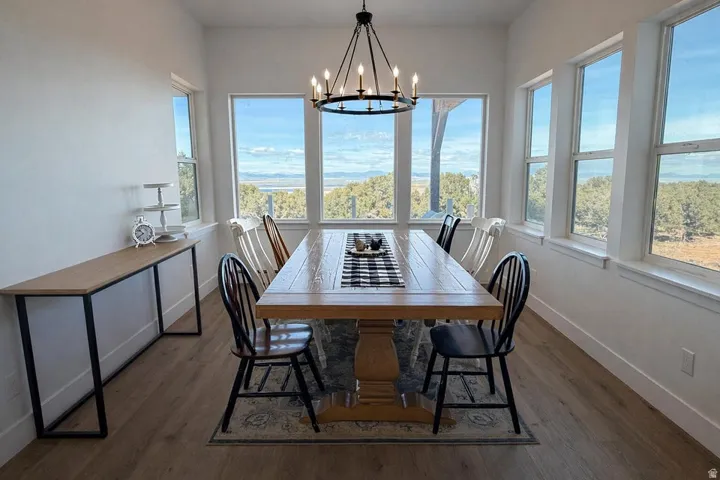 Dining space with dark wood-type flooring and a chandelier