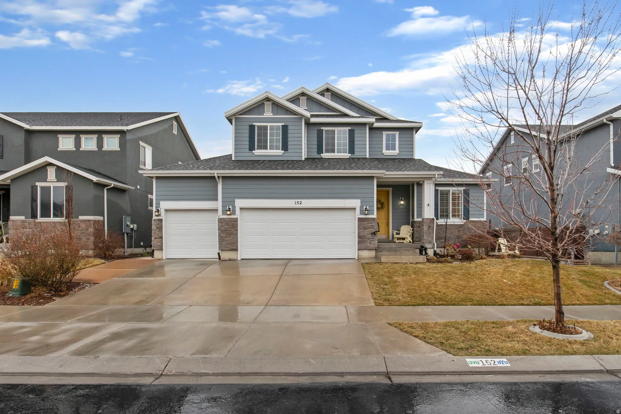 Craftsman-style home with concrete driveway, a front lawn, and an attached garage