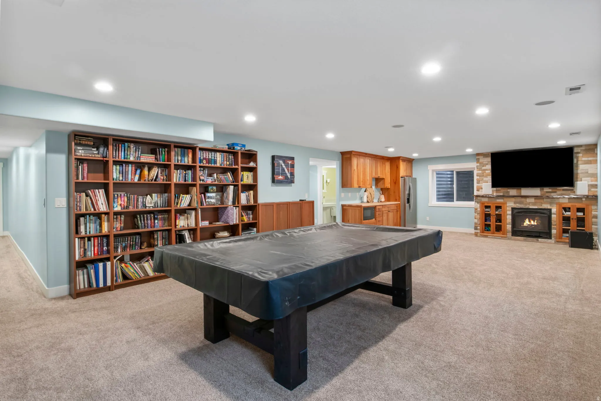 Playroom with light carpet, billiards table, a fireplace, and recessed lighting