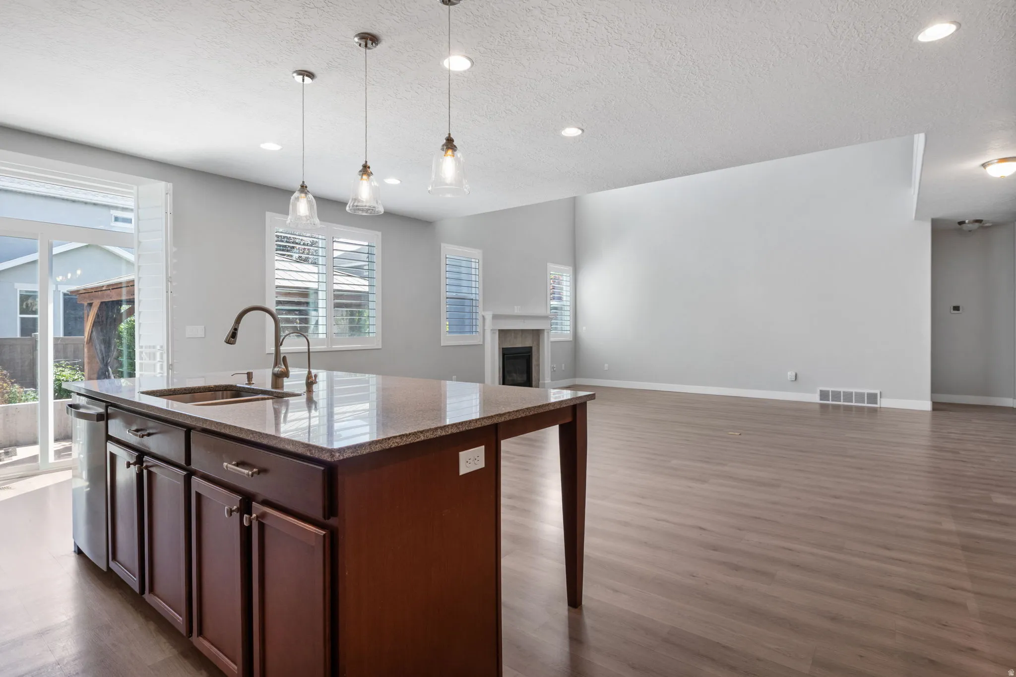 Kitchen island featuring a dual-basin sink, and integrated dishwasher