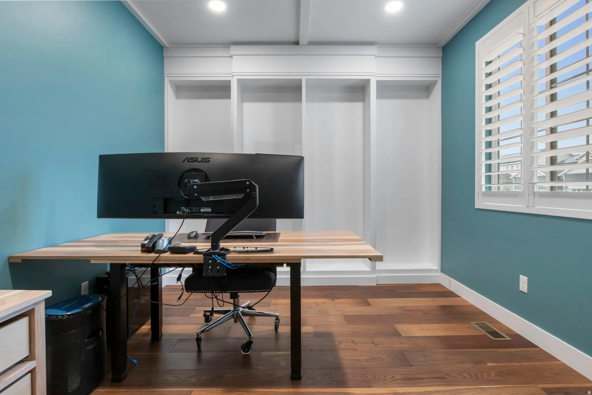 Office space featuring dark wood finished floors and recessed lighting