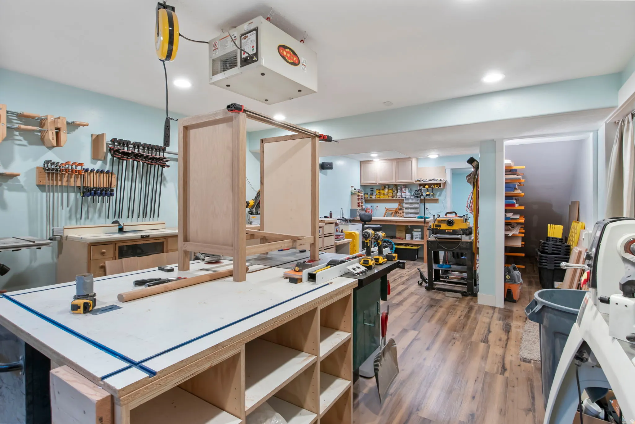 Kitchen featuring a heating unit, dark wood-style floors, a center island, and recessed lighting
