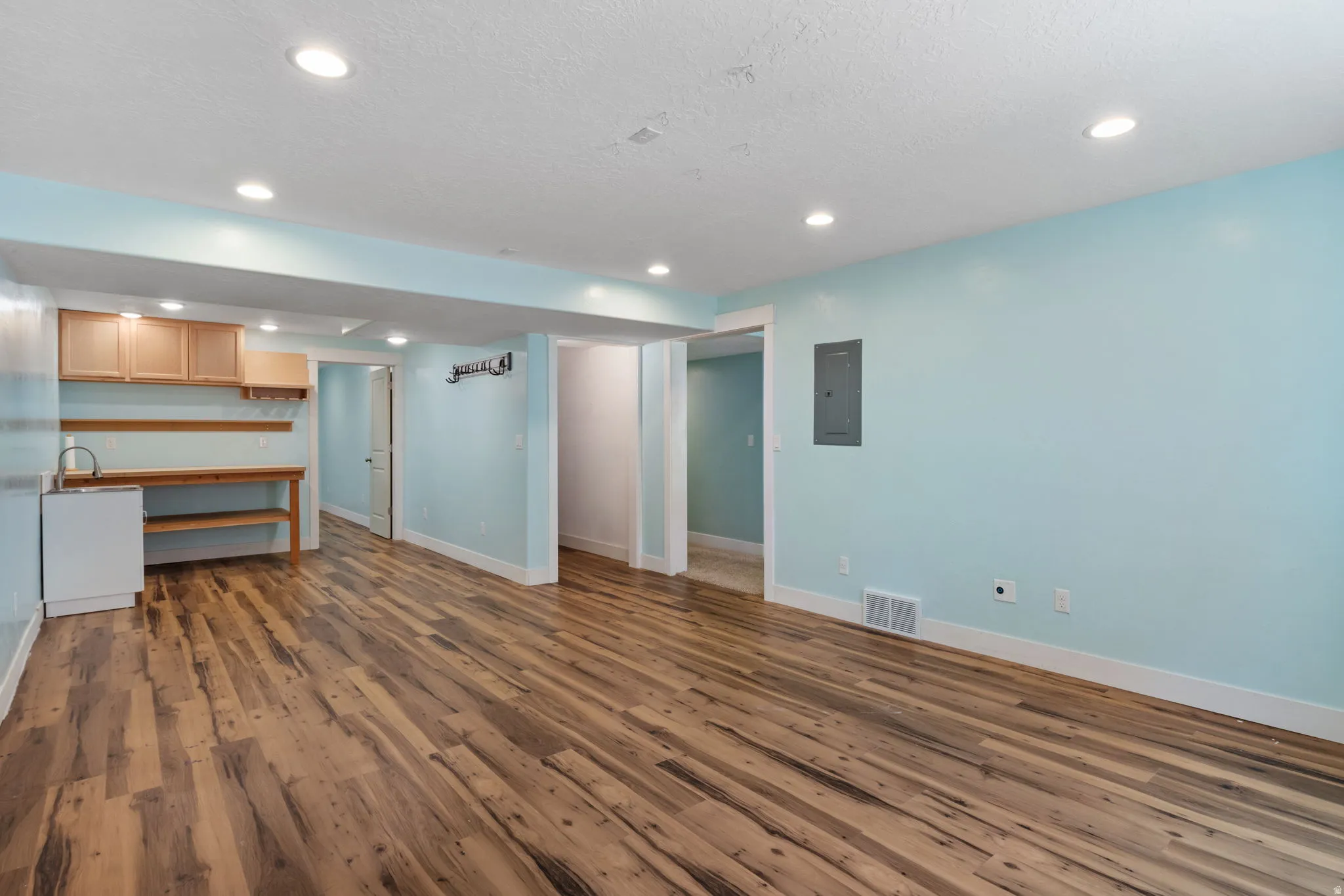 Spacious room featuring wood-finish flooring, recessed lighting. This space can be a mother-in-law due to plumbing for bathroom kitchenette, a playroom or game room.
