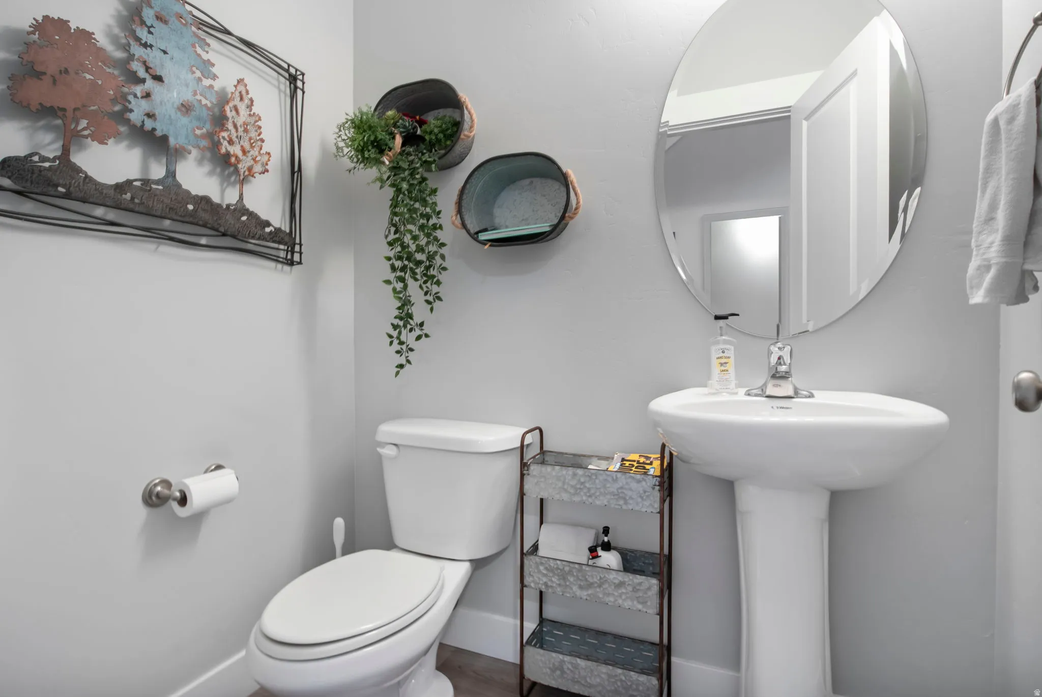 Half bathroom with toilet and baseboards