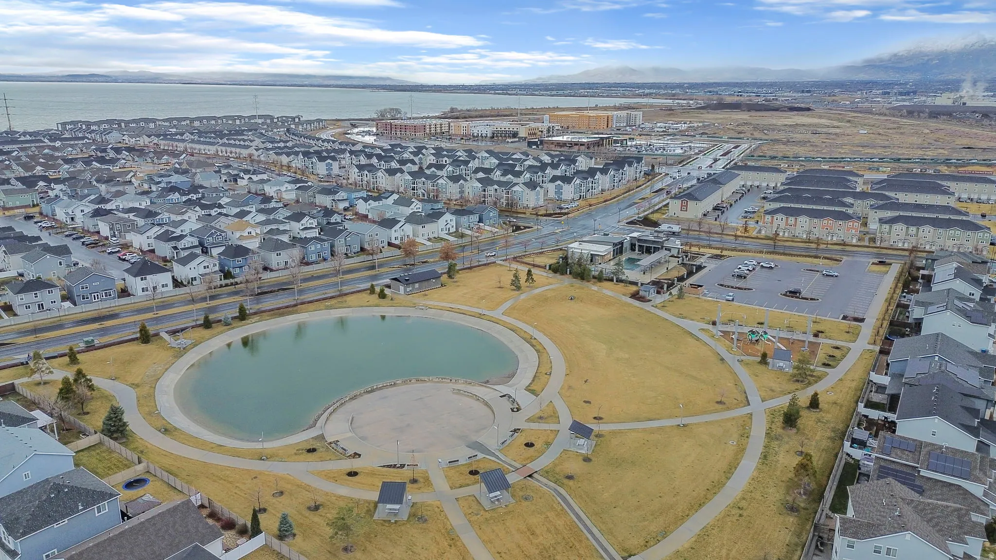 View of property location with a large body of water and nearby suburban area