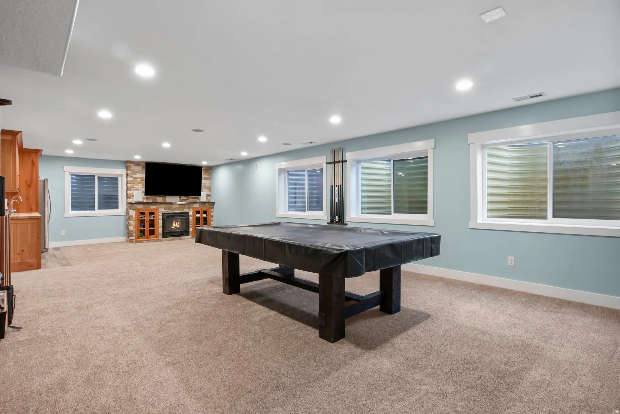 Playroom with billiards table, light carpet, a fireplace, and recessed lighting