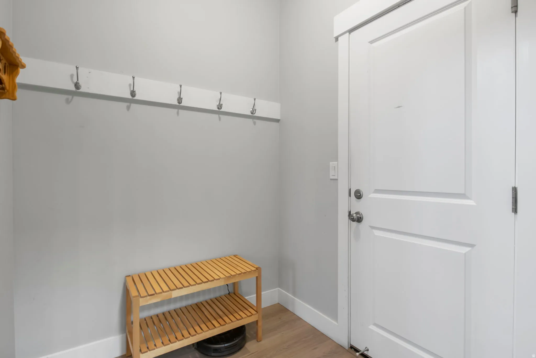 Mudroom featuring baseboards and light wood-style flooring