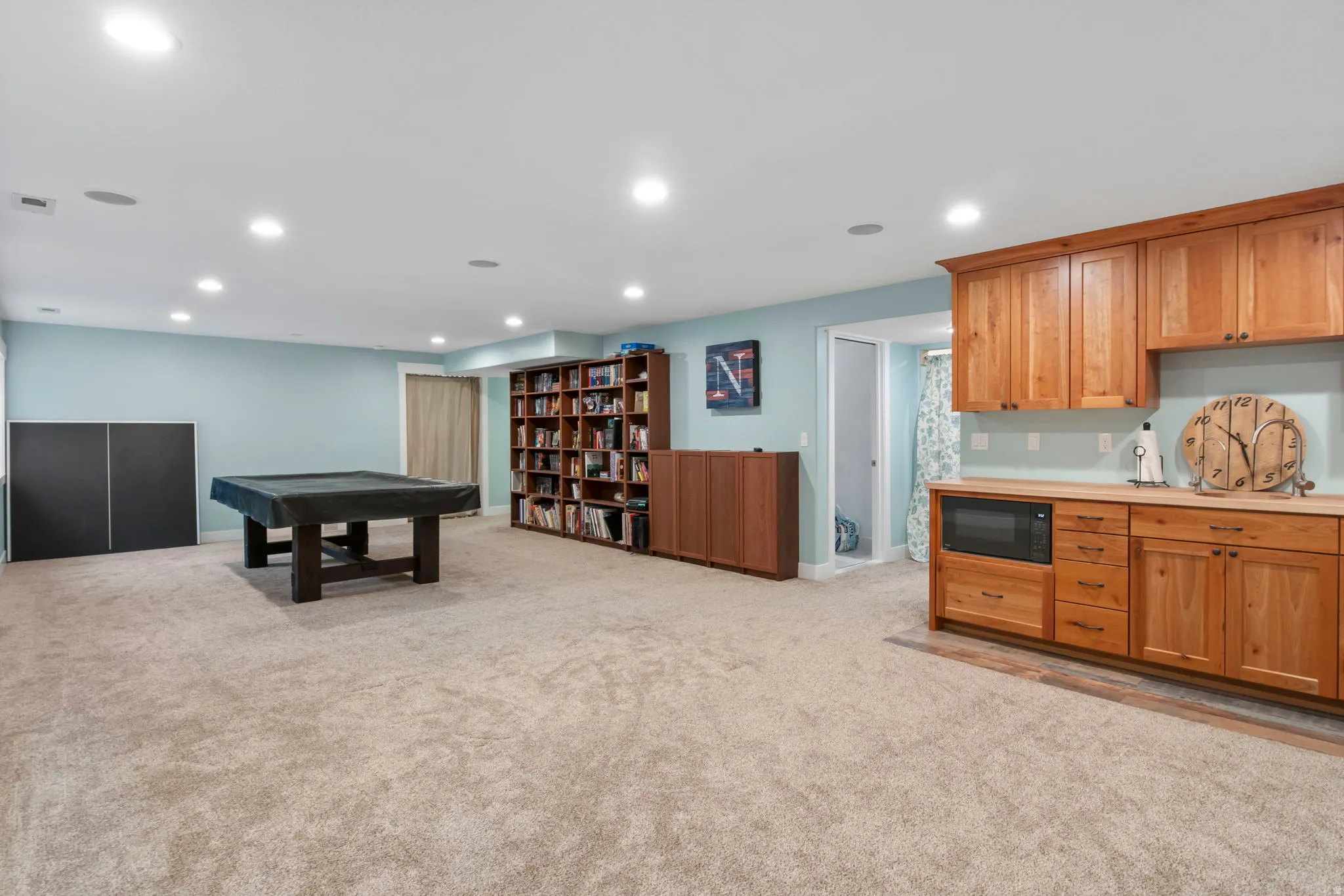 Rec room with light carpet and recessed lighting