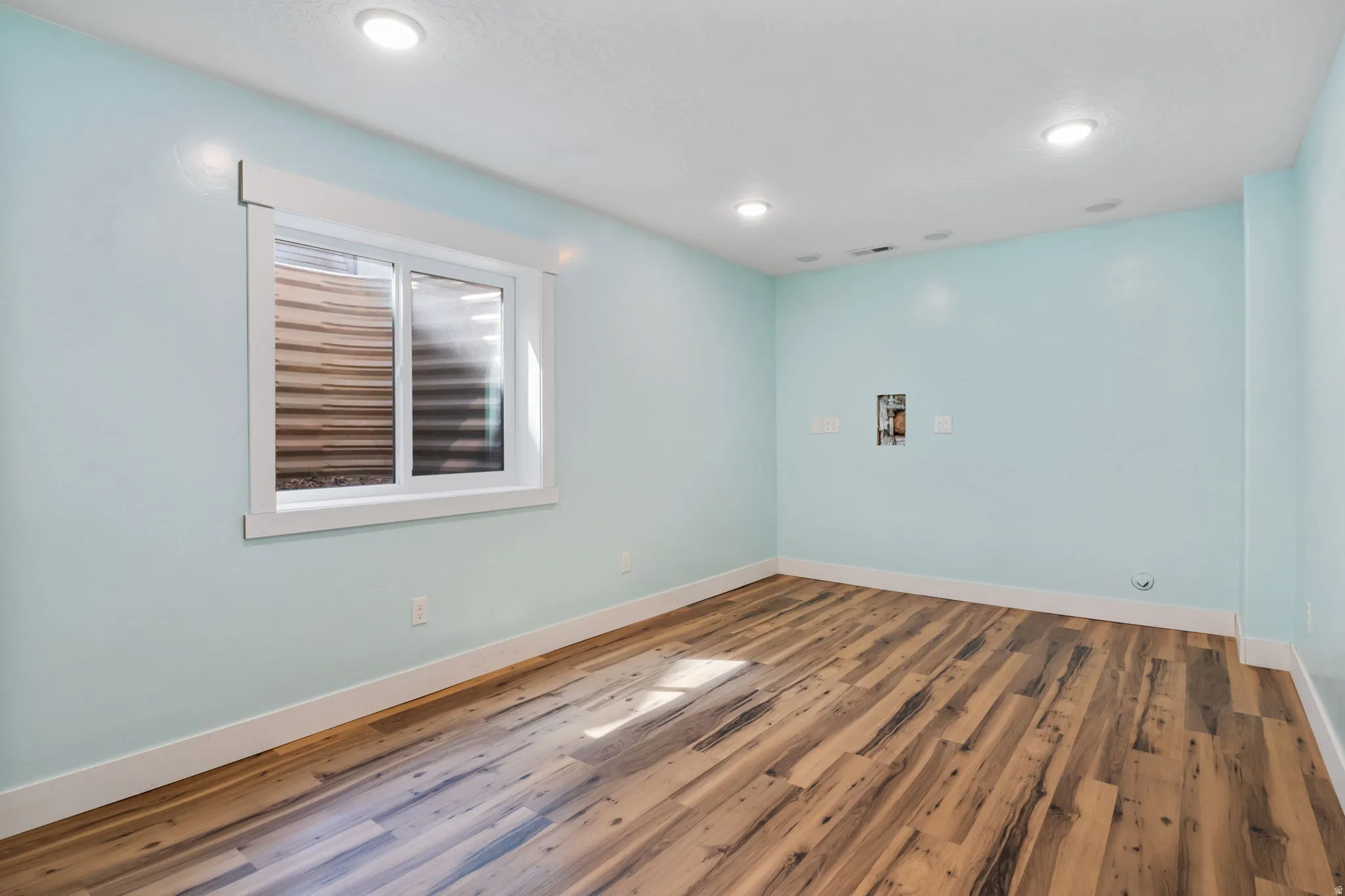 5th bedroom featuring wood-finish flooring and recessed lighting. Seller will professionally install a closet in the location of your choice.