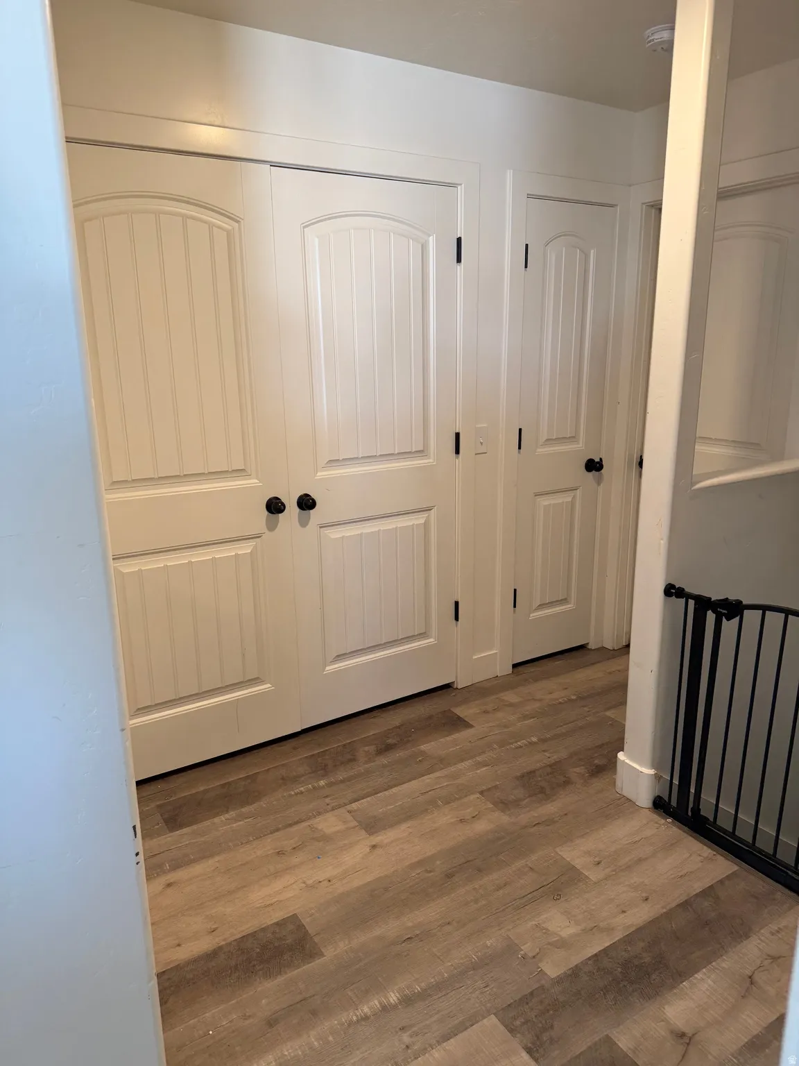Corridor featuring wood finished floors