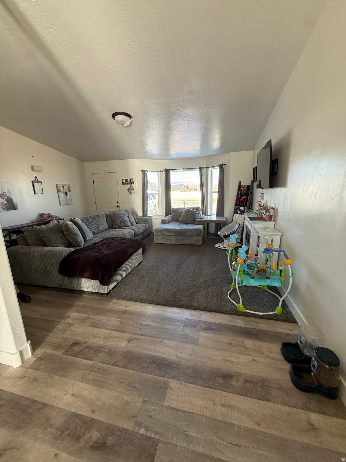 Living area with wood finished floors and baseboards
