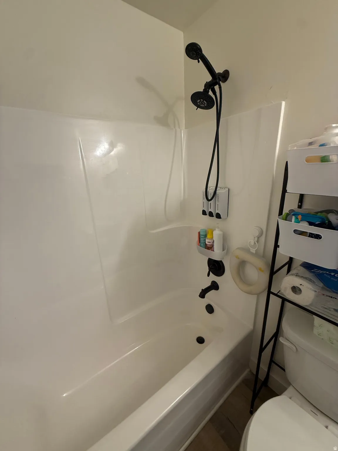 Bathroom featuring toilet and shower / washtub combination