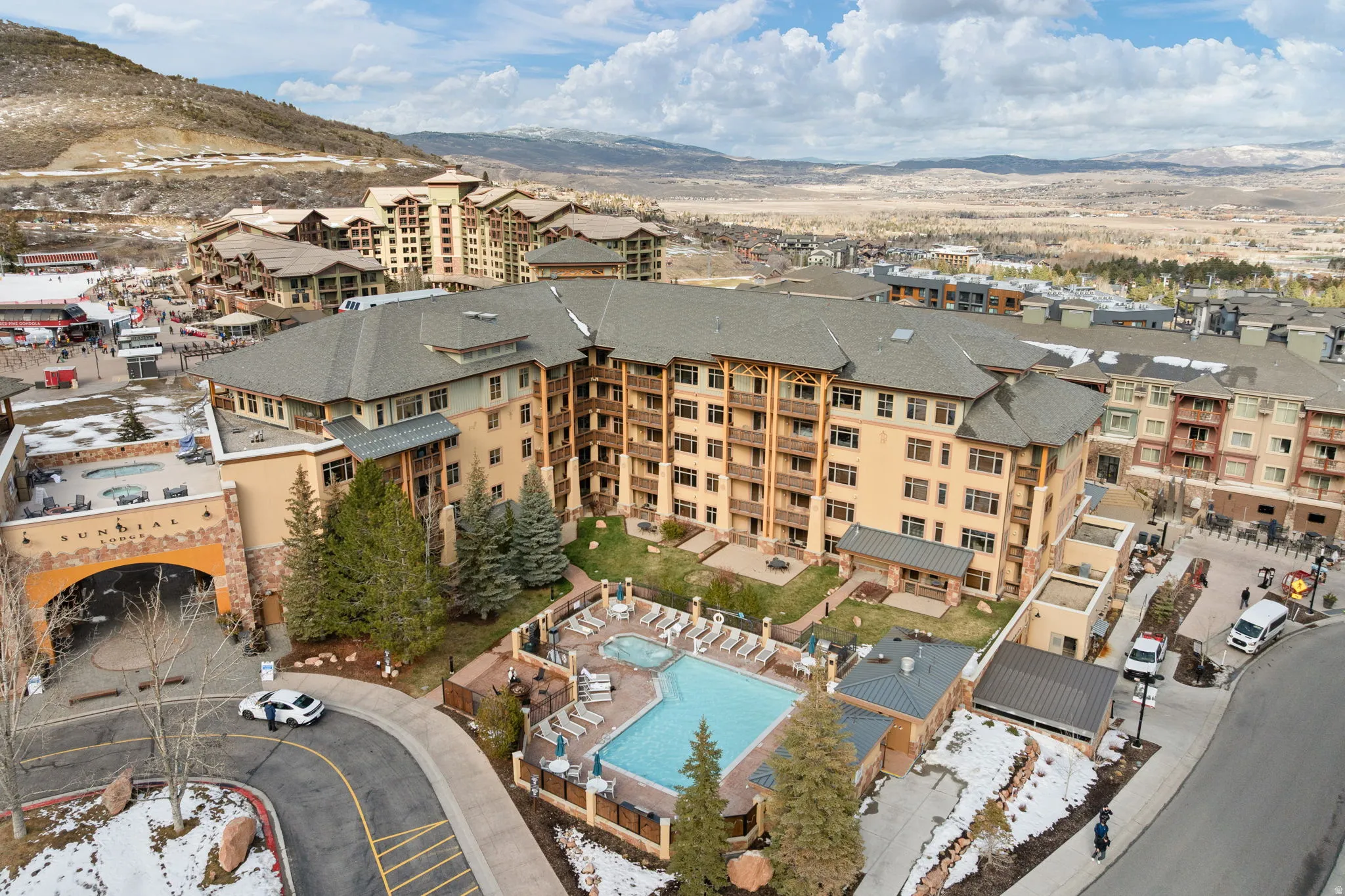 Aerial view of a mountain backdrop and a pool area