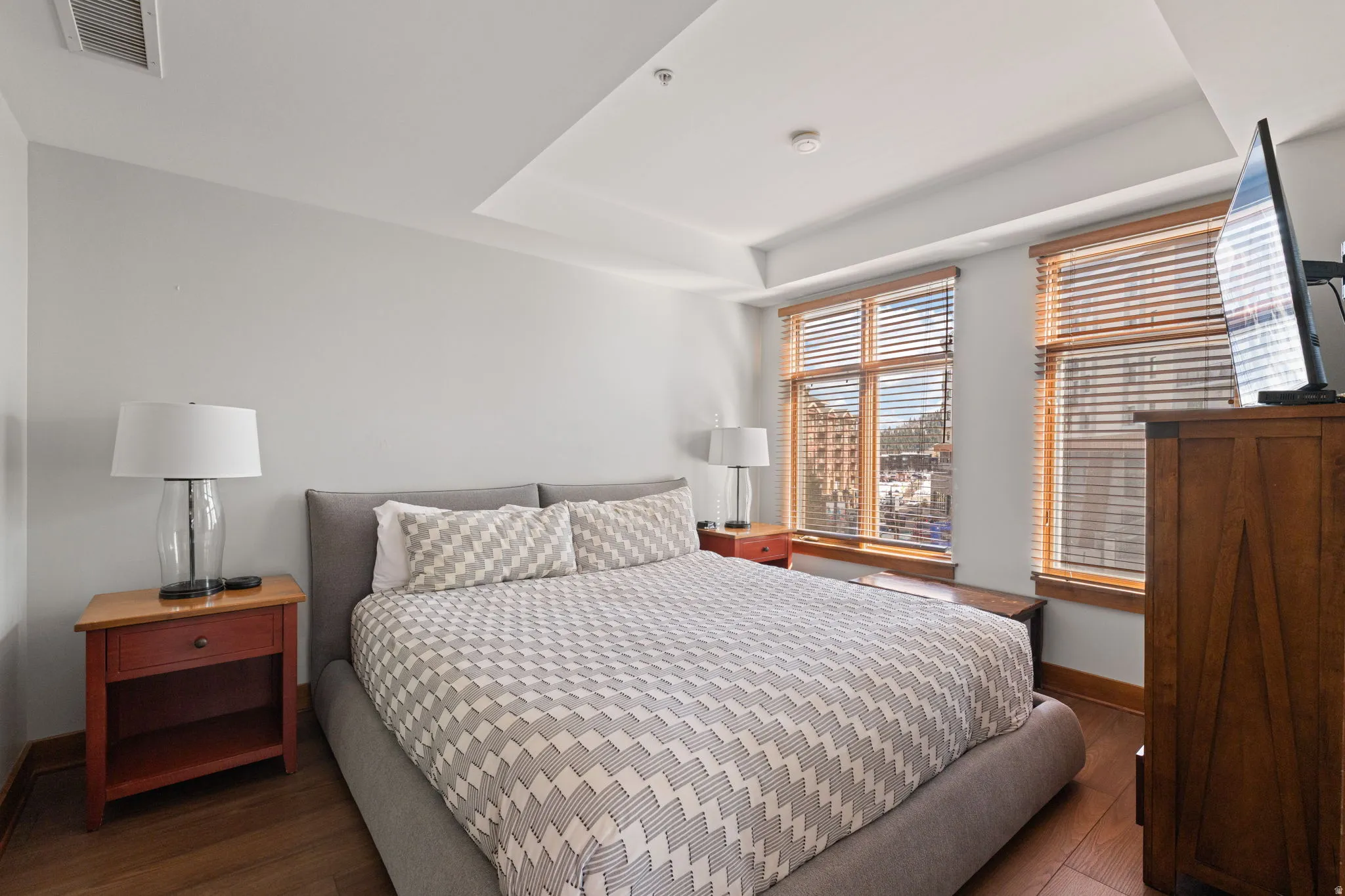 Bedroom featuring hardwood / wood-style flooring and baseboards