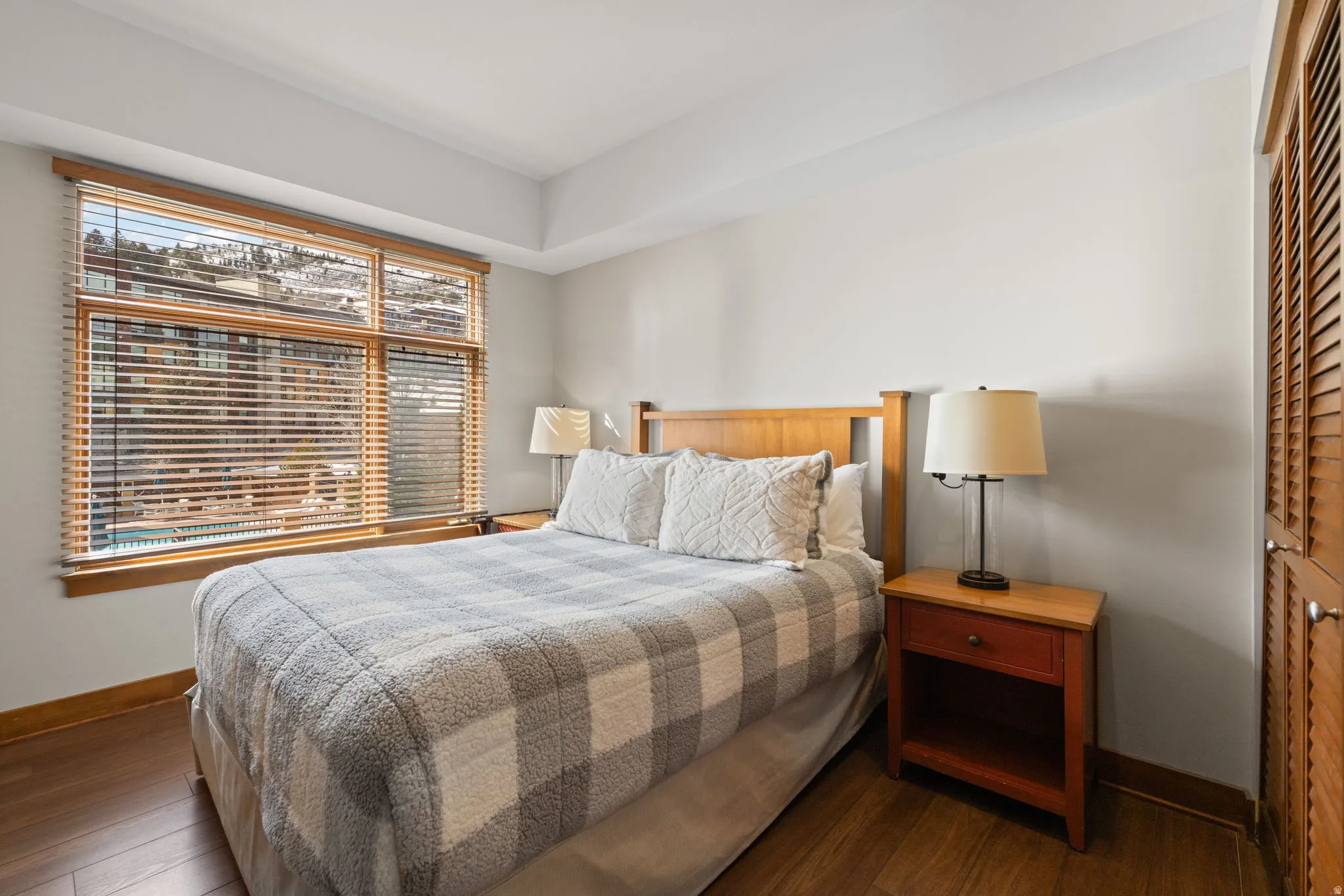 Bedroom with dark wood-type flooring and a closet