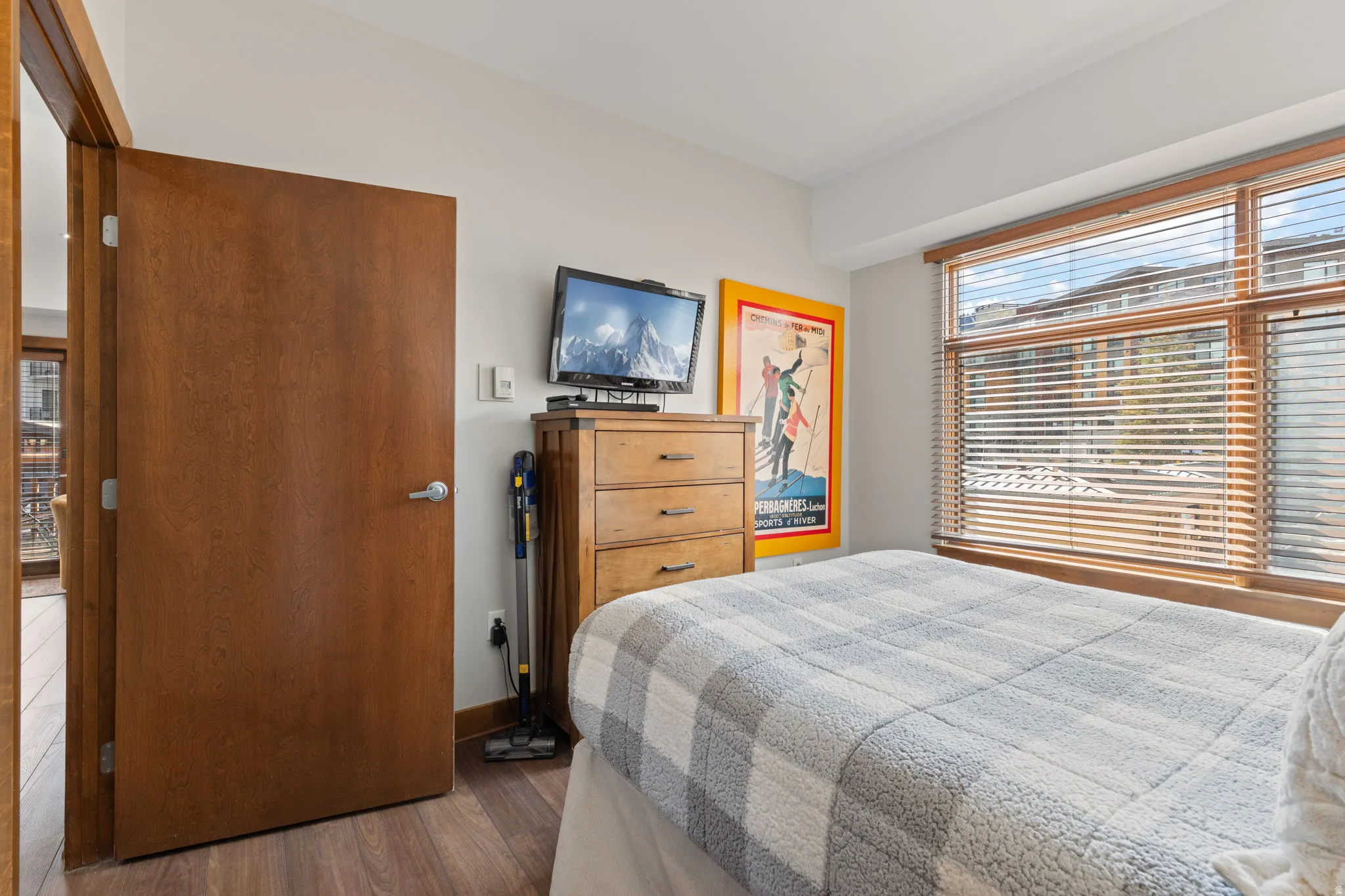 Bedroom featuring dark wood-style flooring and baseboards