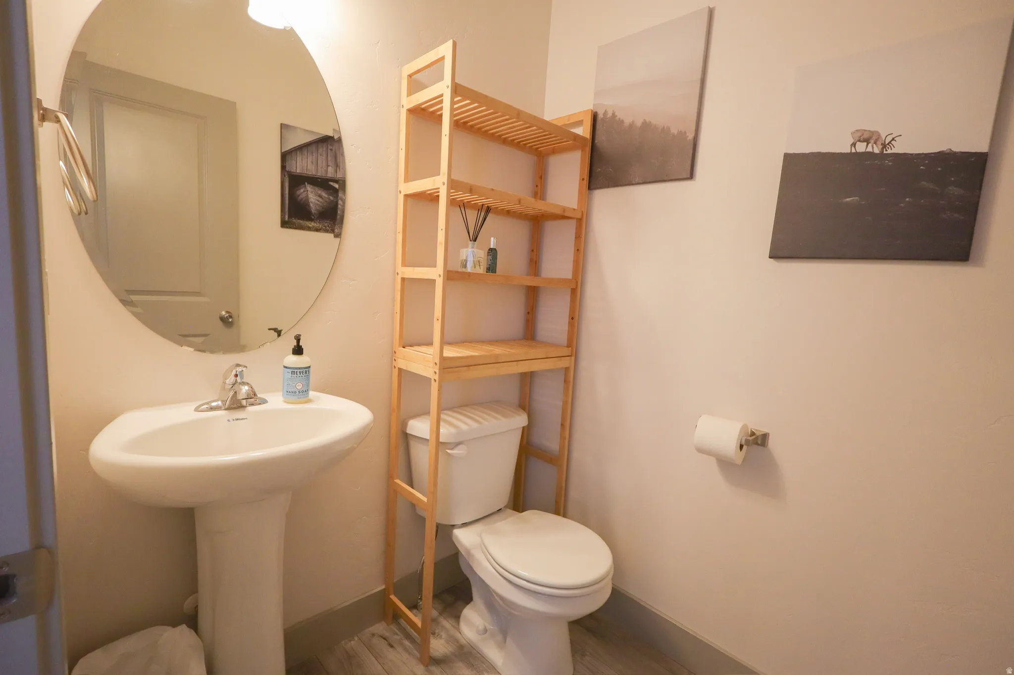 Bathroom featuring toilet and light wood finished floors