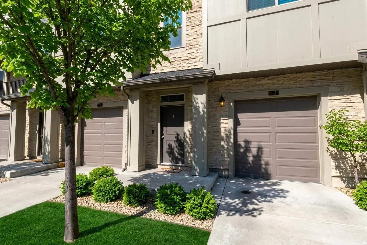 Property entrance with a garage and concrete driveway