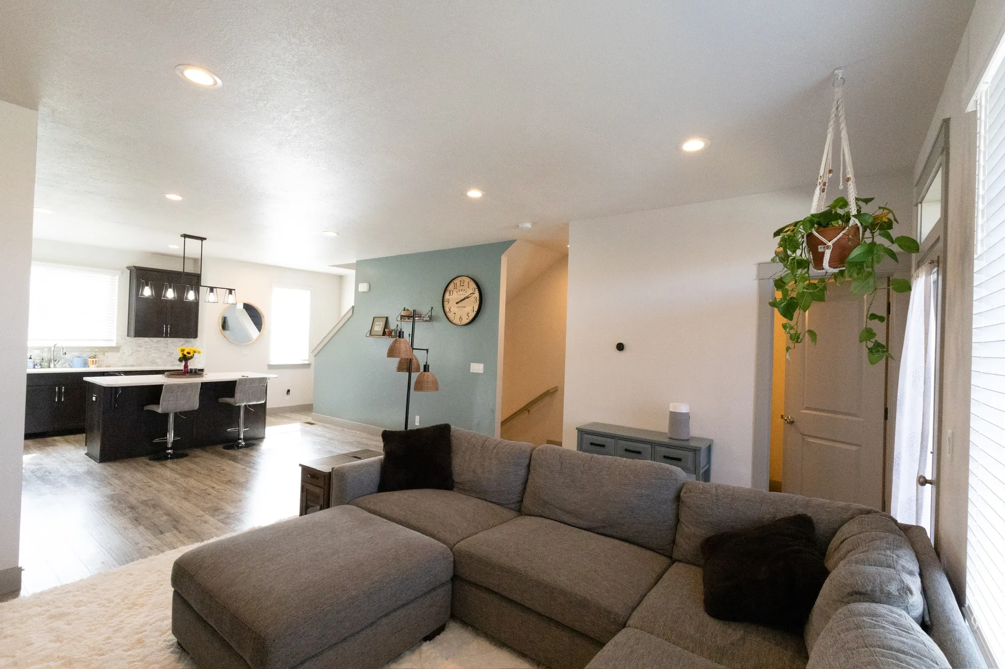 Living room with light wood finished floors and recessed lighting