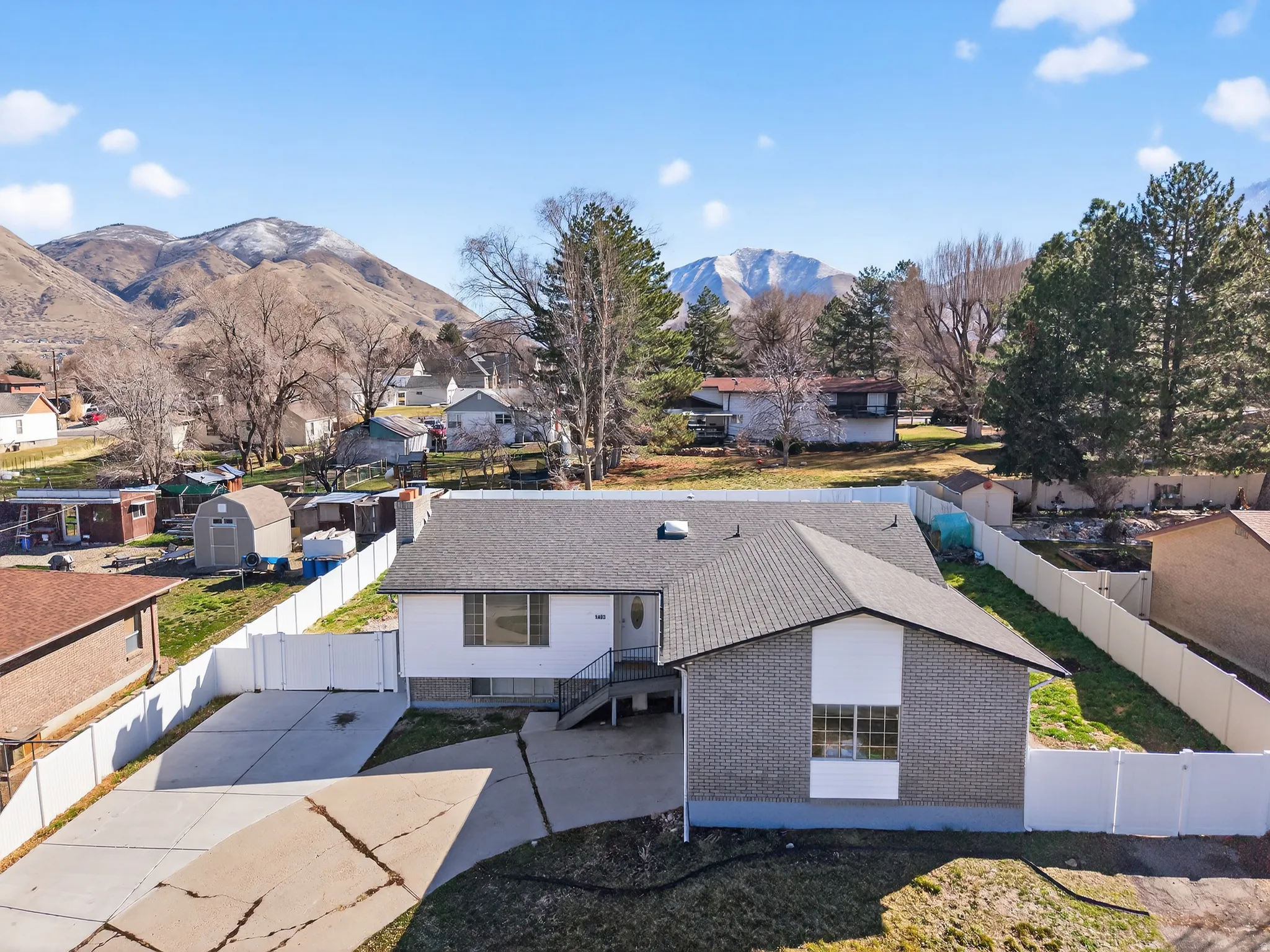 Aerial perspective of suburban area featuring a mountain backdrop