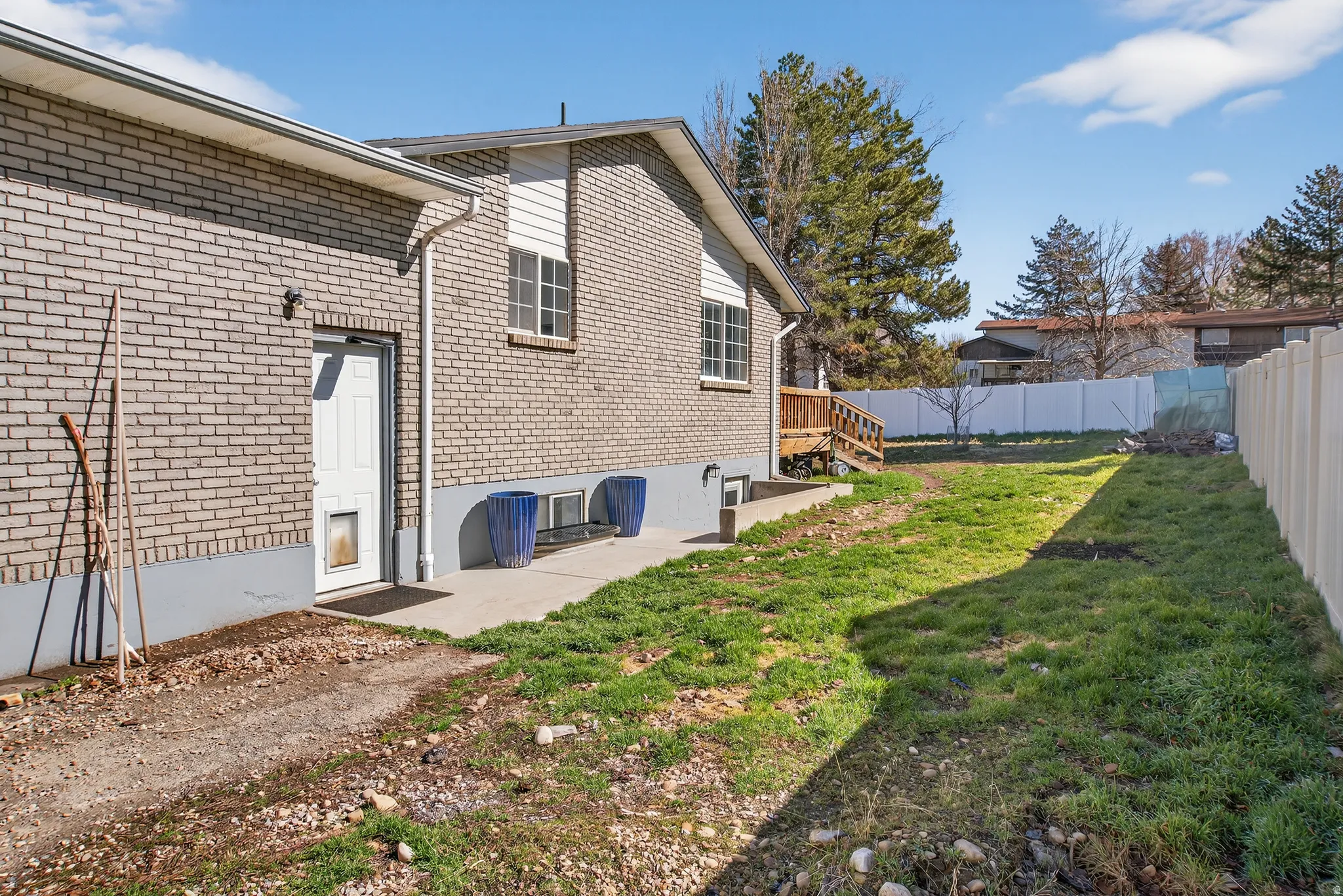 Back of property featuring a patio, a fenced backyard, and brick siding