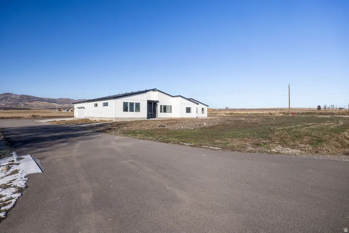 View of front facade with a garage and a mountain view